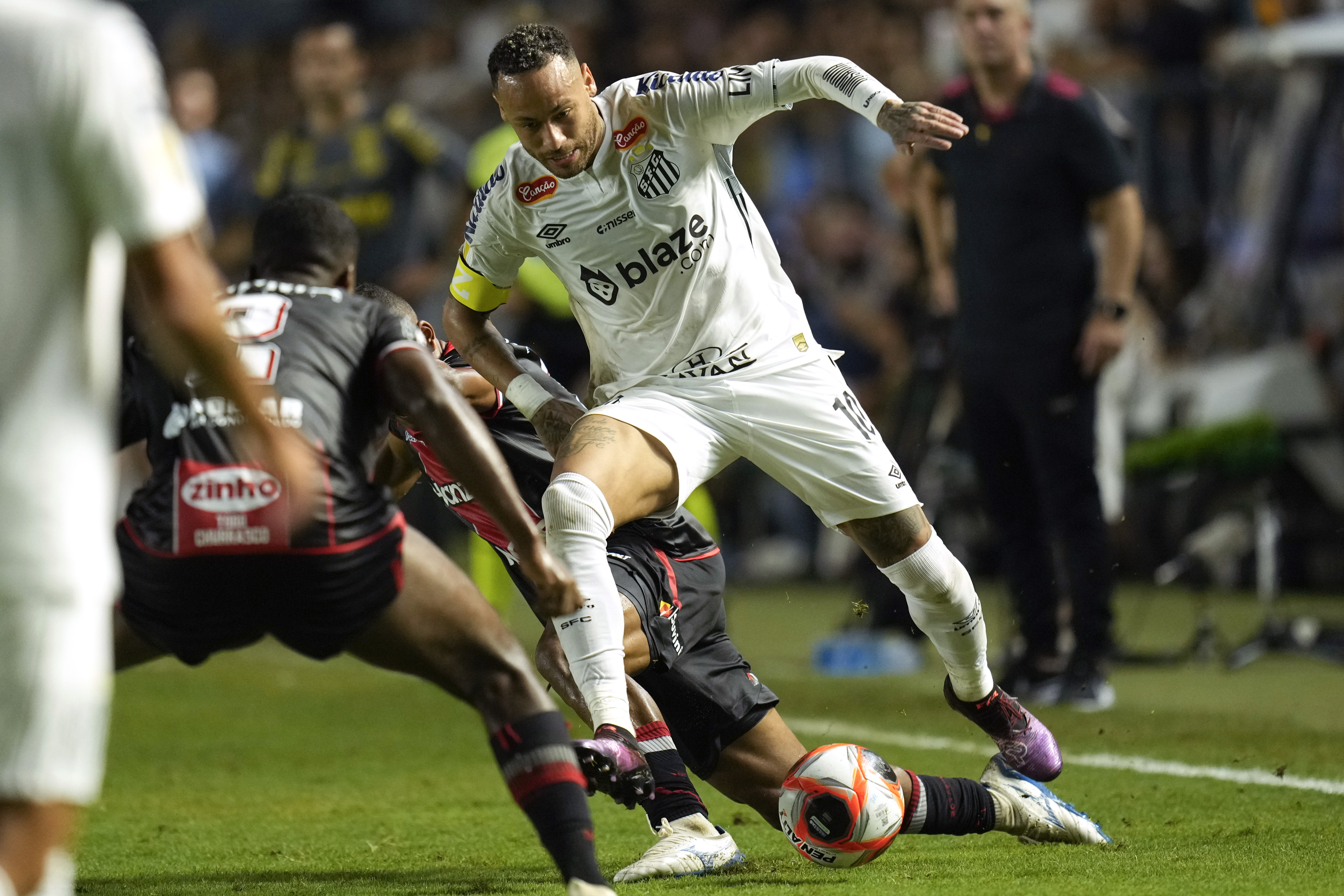 Brazil’s Neymar is tackled as he chases a ball during his debut for Santos FC in a Sao Paulo league football match against Botafogo-SP, in Santos, Brazil, Wednesday, February 5, 2025