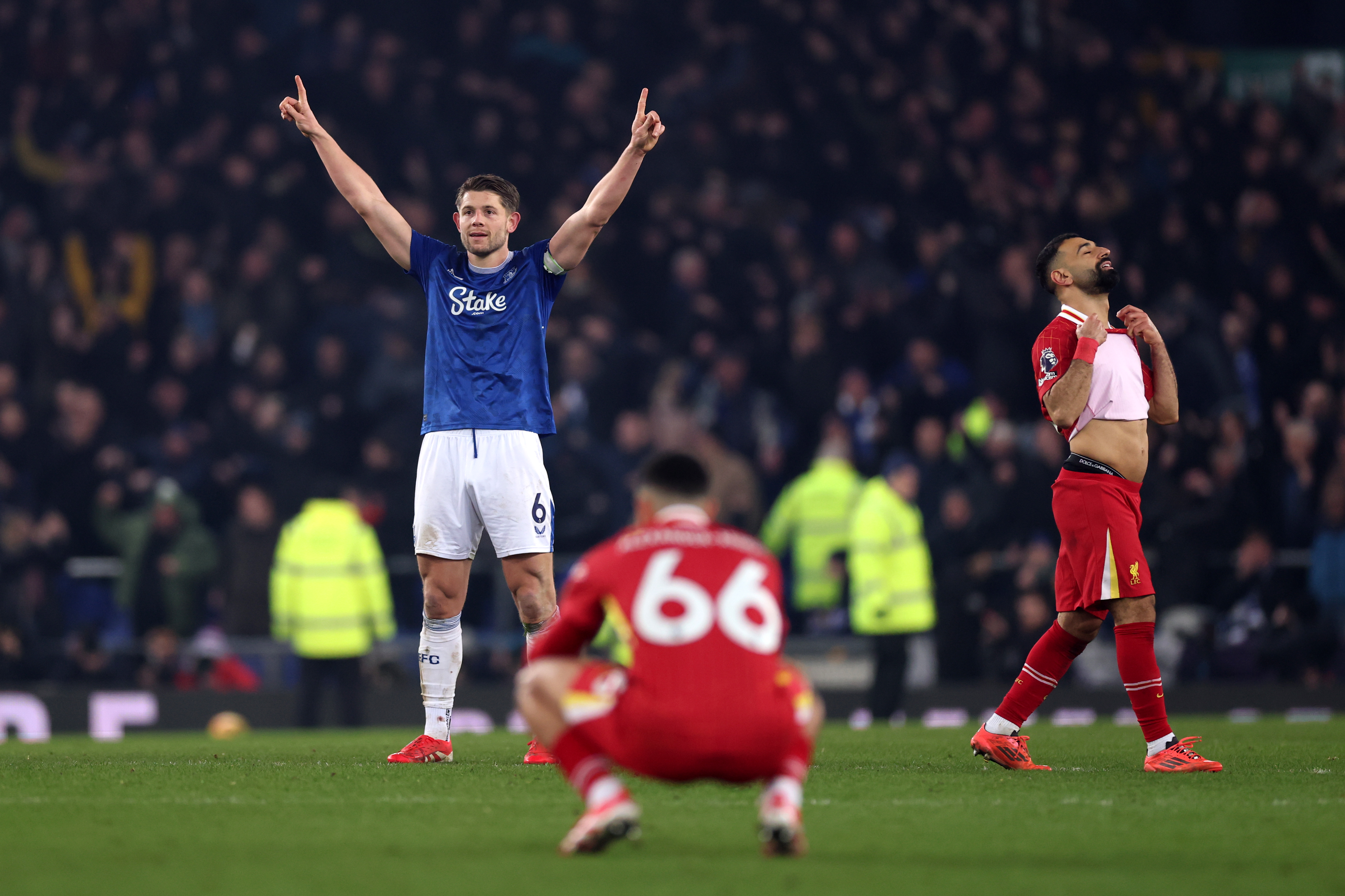 LIVERPOOL, ENGLAND - FEBRUARY 12: James Tarkowski of Everton celebrates after his goal stands following a VAR review as Trent Alexander-Arnold and Mohamed Salah of Liverpool look dejected during the Premier League match between Everton FC and Liverpool FC at Goodison Park on February 12, 2025 in Liverpool, England. (Photo by Carl Recine/Getty Images)