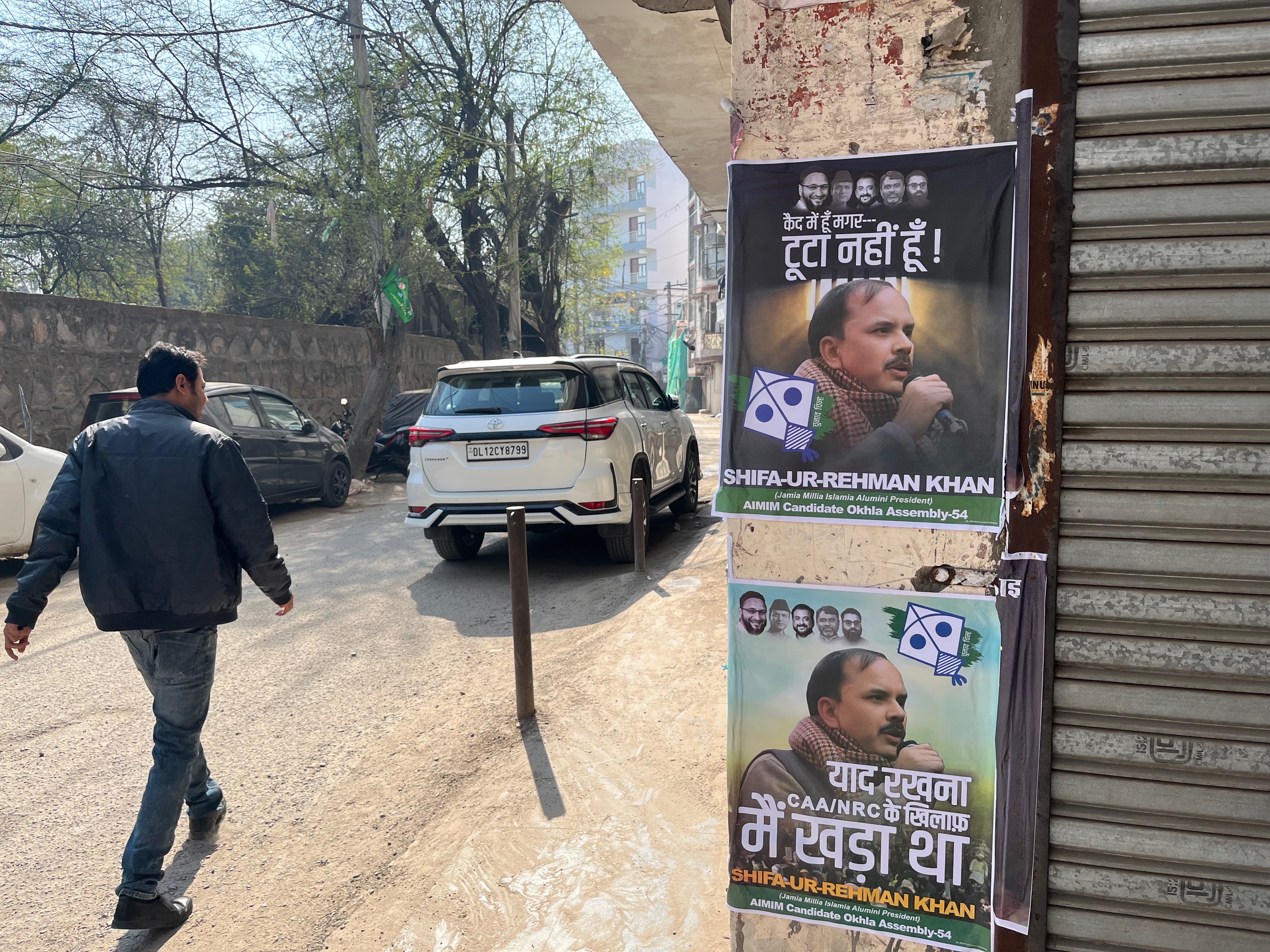 Posters of Shifa ur Rehman in the lane leading up to his home in Okhla, New Delhi