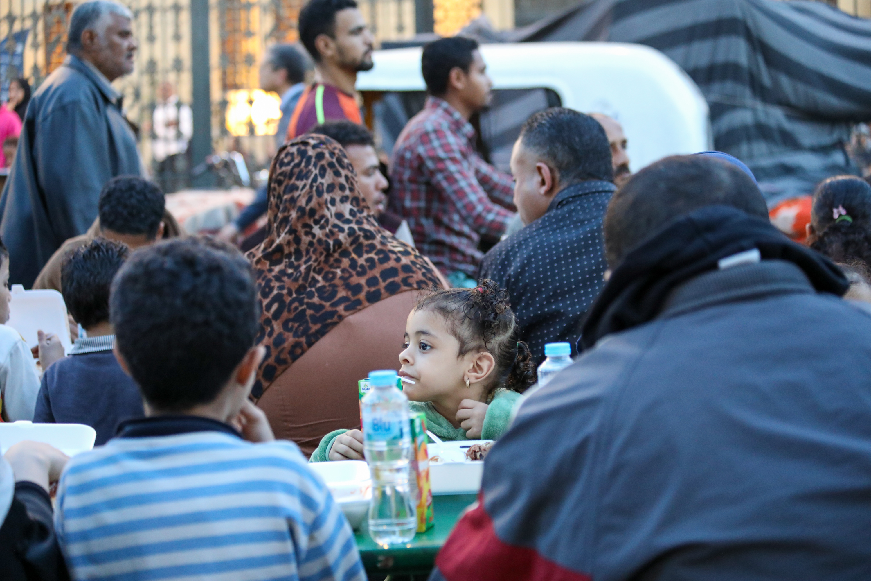 About 400 people break their fast at this table of mercy with water, juice, dates and a food box that includes rice, chicken and a bean stew [Al Jazeera]
