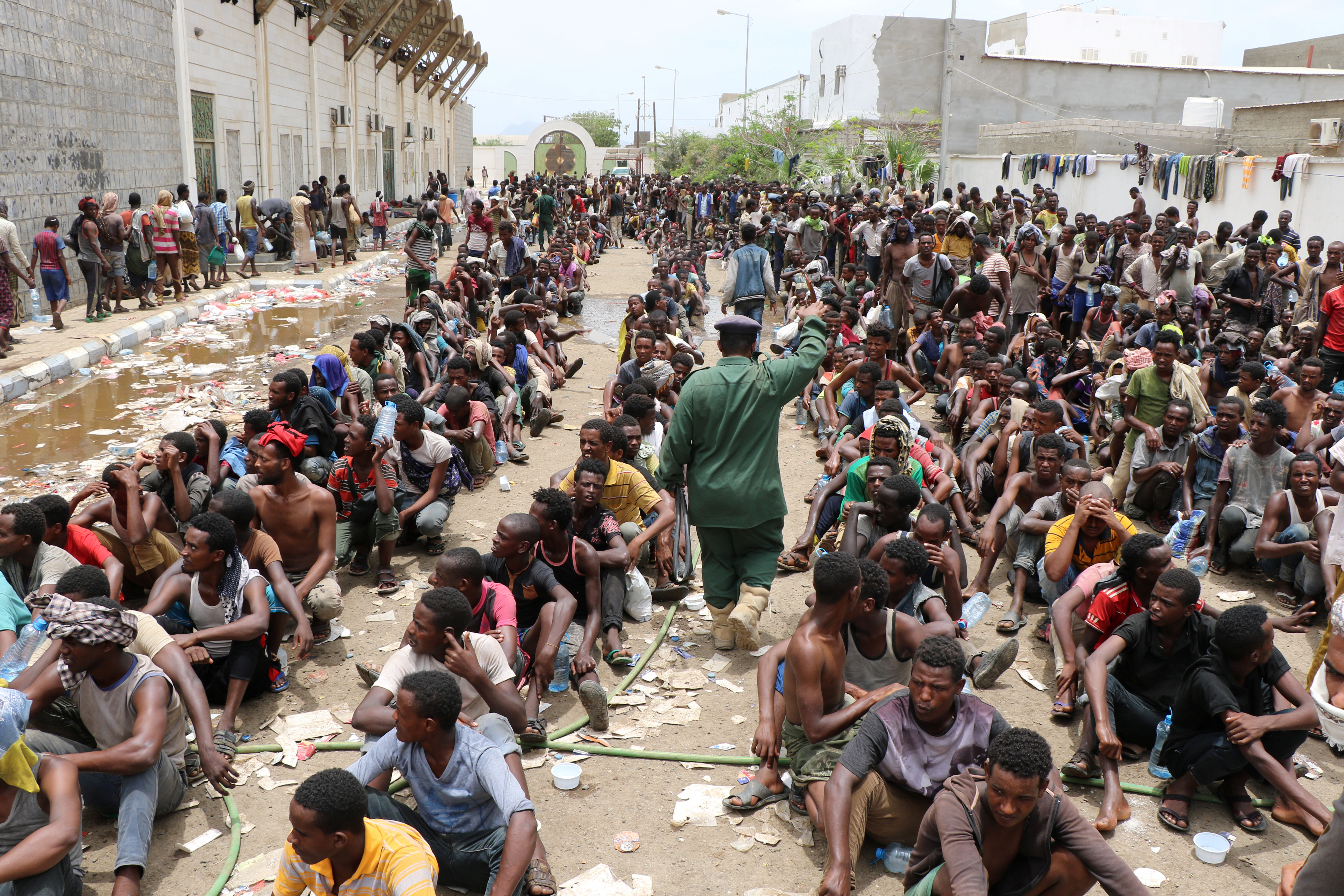 Ethiopian migrants, stranded in war-torn Yemen, sit on the ground of a detention site pending repatriation to their home country, in Aden, Yemen April 24, 2019. REUTERS/Fawaz Salman