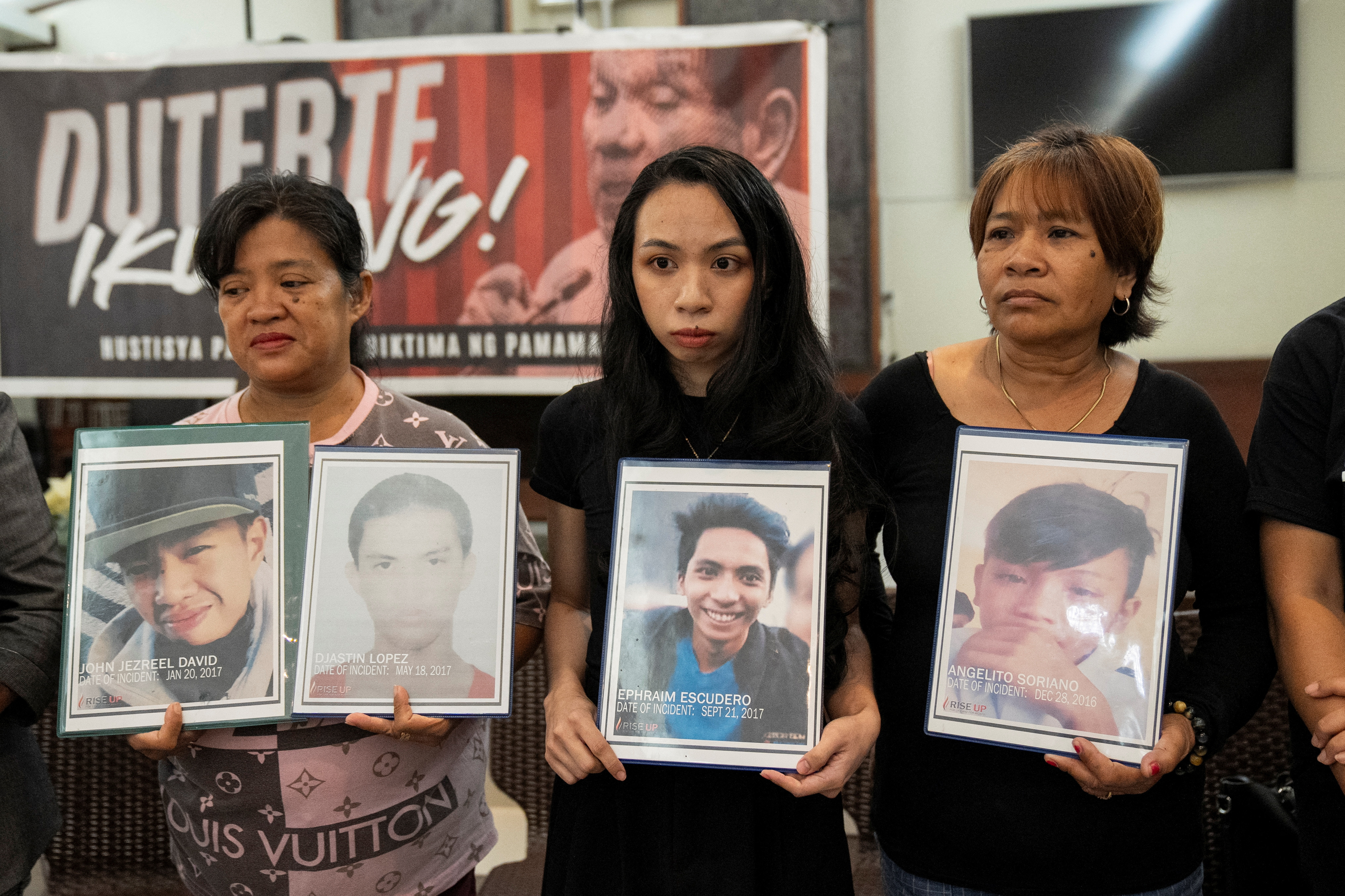 Relatives hold pictures of drug war and extrajudicial killing victims during a press conference following the arrest of former Philippine President Rodrigo Duterte, in Quezon City, Metro Manila, Philippines, March 12, 2025. REUTERS/Lisa Marie David