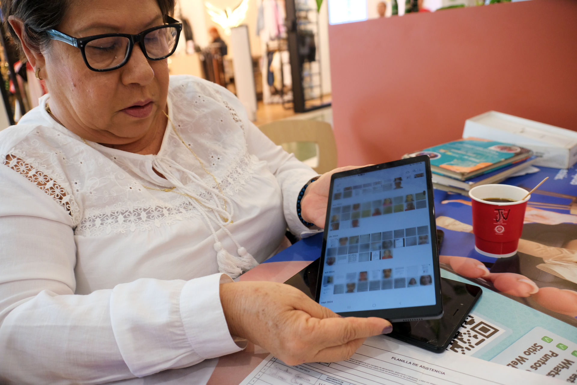 Adriana Llano Medina works as a volunteer to register Venezuelan children for their migration documents. Faces have been blurred for applicants' privacy