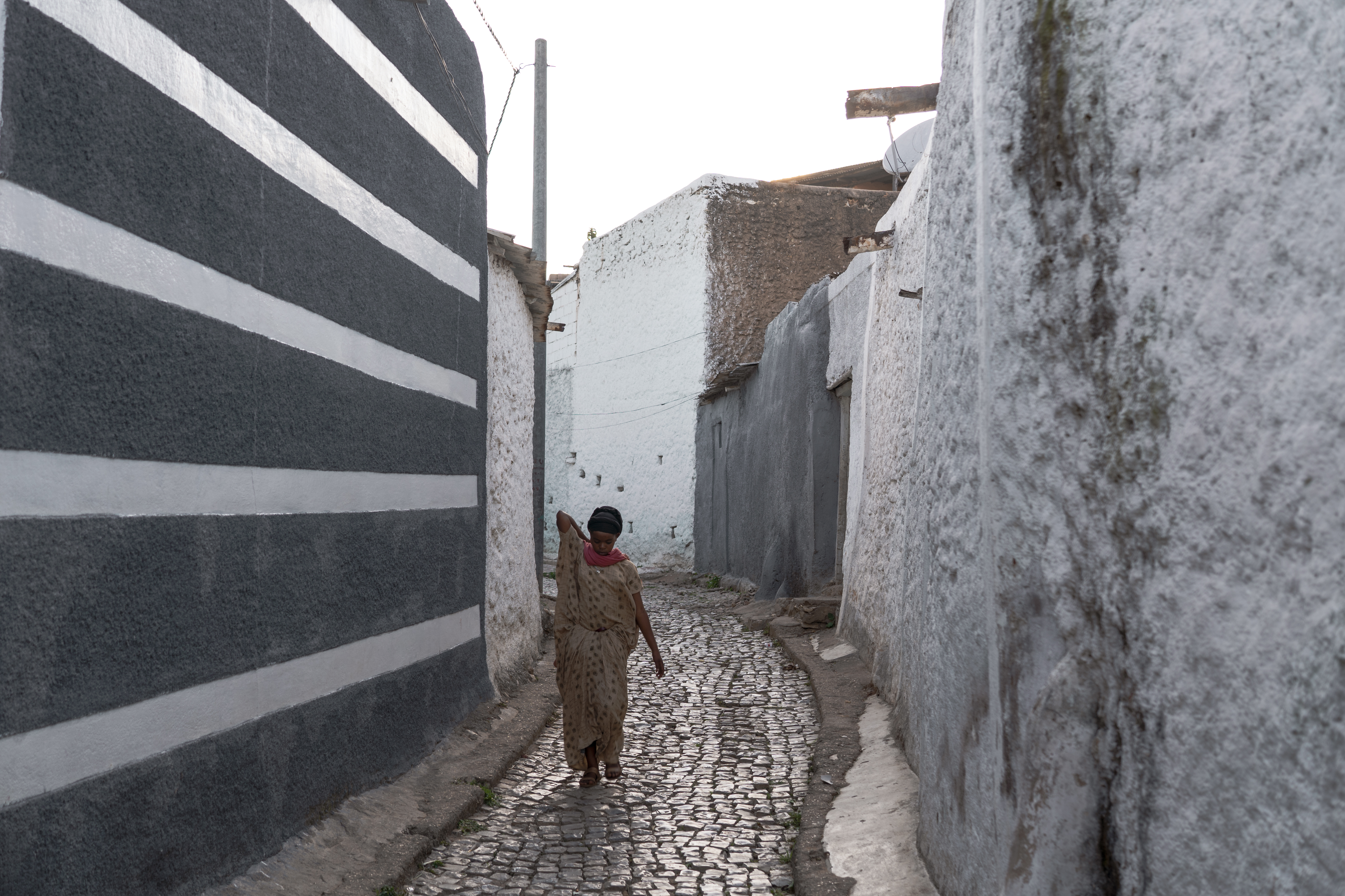 A woman walks through one of the narrow streets of Harar’s old walled city
