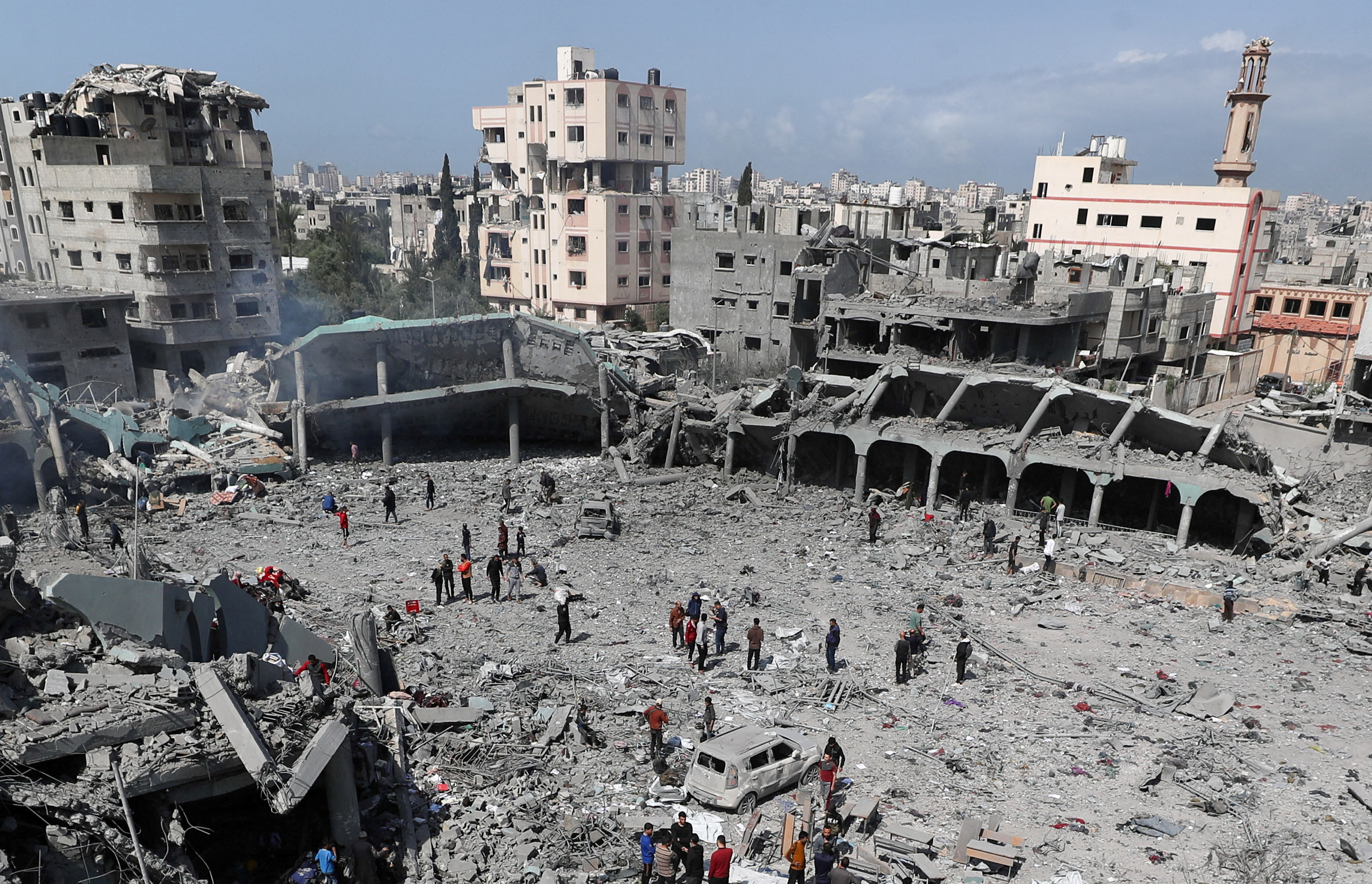 Palestinians inspect the damage at the Dar Al-Arqam School.