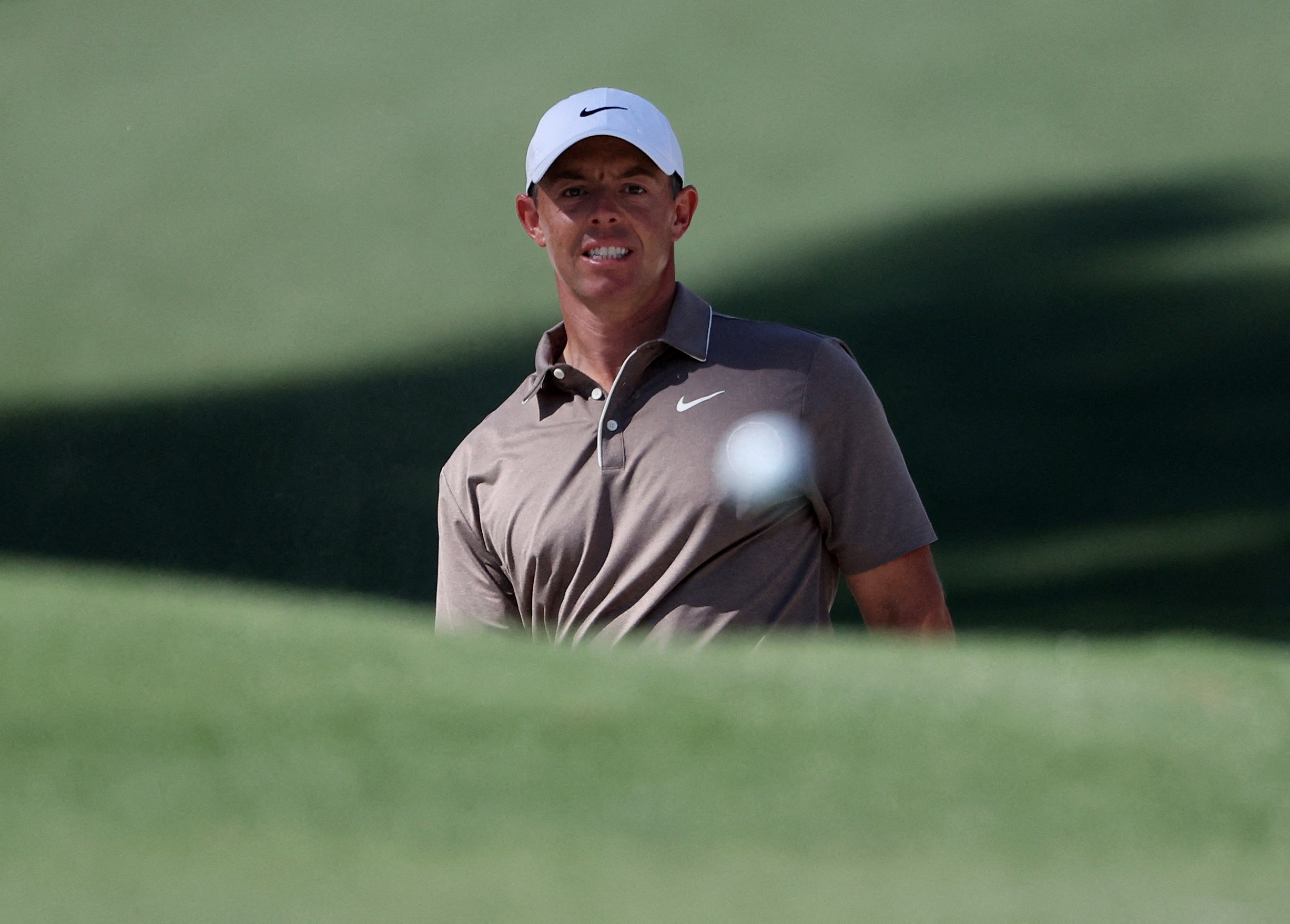 Golf - The Masters - Augusta National Golf Club, Augusta, Georgia, U.S. - April 10, 2025 Northern Ireland's Rory McIlroy watches his shot out from the bunker on the 10th hole during the first round REUTERS/Pilar Olivares TPX IMAGES OF THE DAY