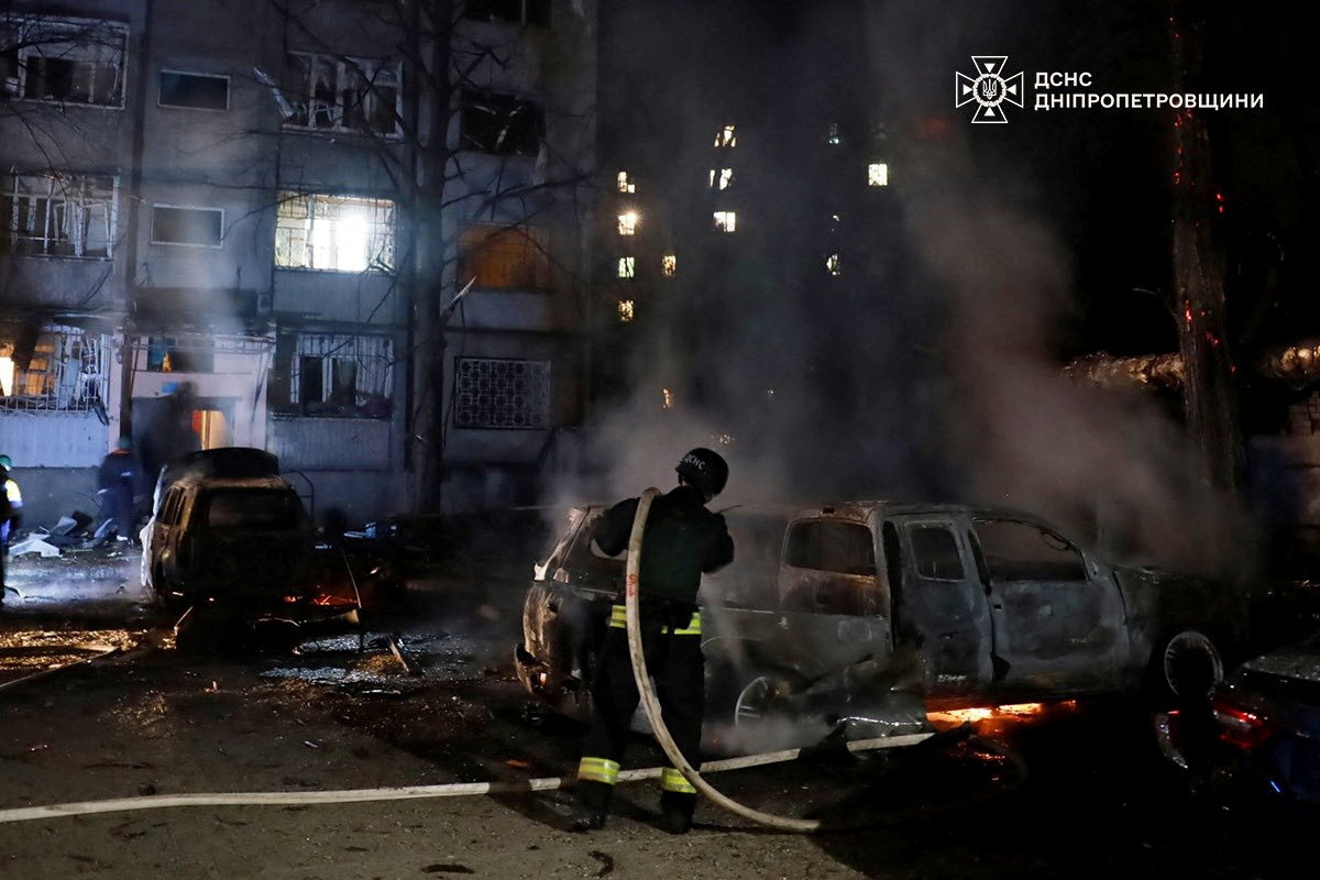 A firefighter extinguishes a burning car at the site of a Russian drone strike, amid Russia's attack on Ukraine, in Dnipro, Ukraine, in this handout picture released April 17, 2025. Press service of the State Emergency Service of Ukraine/Handout via REUTERS THIS IMAGE HAS BEEN SUPPLIED BY A THIRD PARTY. DO NOT OBSCURE LOGO. BEST QUALITY AVALIABLE.