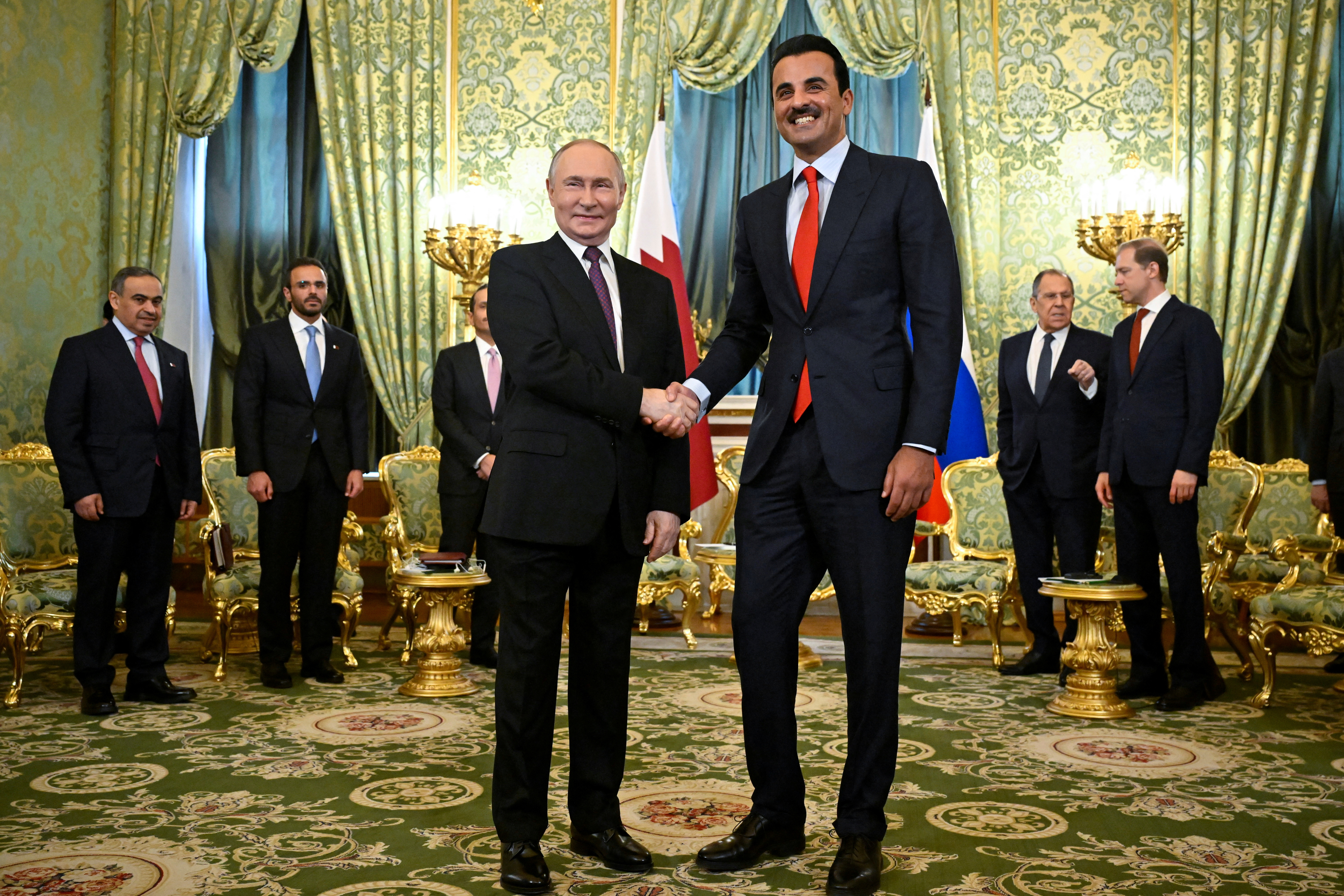 Russia's President Vladimir Putin shakes hands with Qatar's Emir, Sheikh Tamim bin Hamad Al Thani during a meeting at the Kremlin in Moscow, Russia