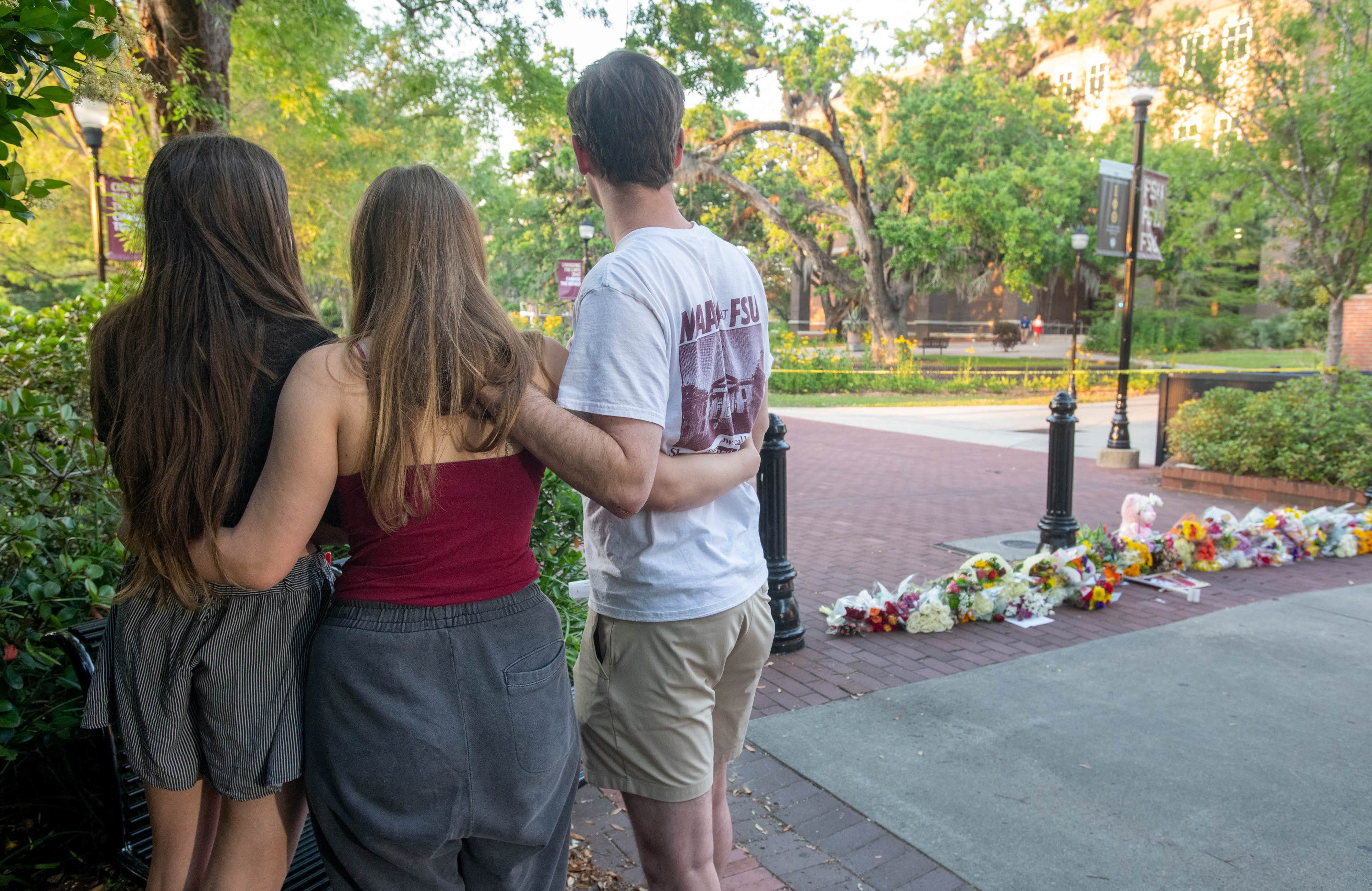 People gather at a makeshift memorial near the scene of a shooting on the Florida State University campus in Tallahassee, Florida, on April 17