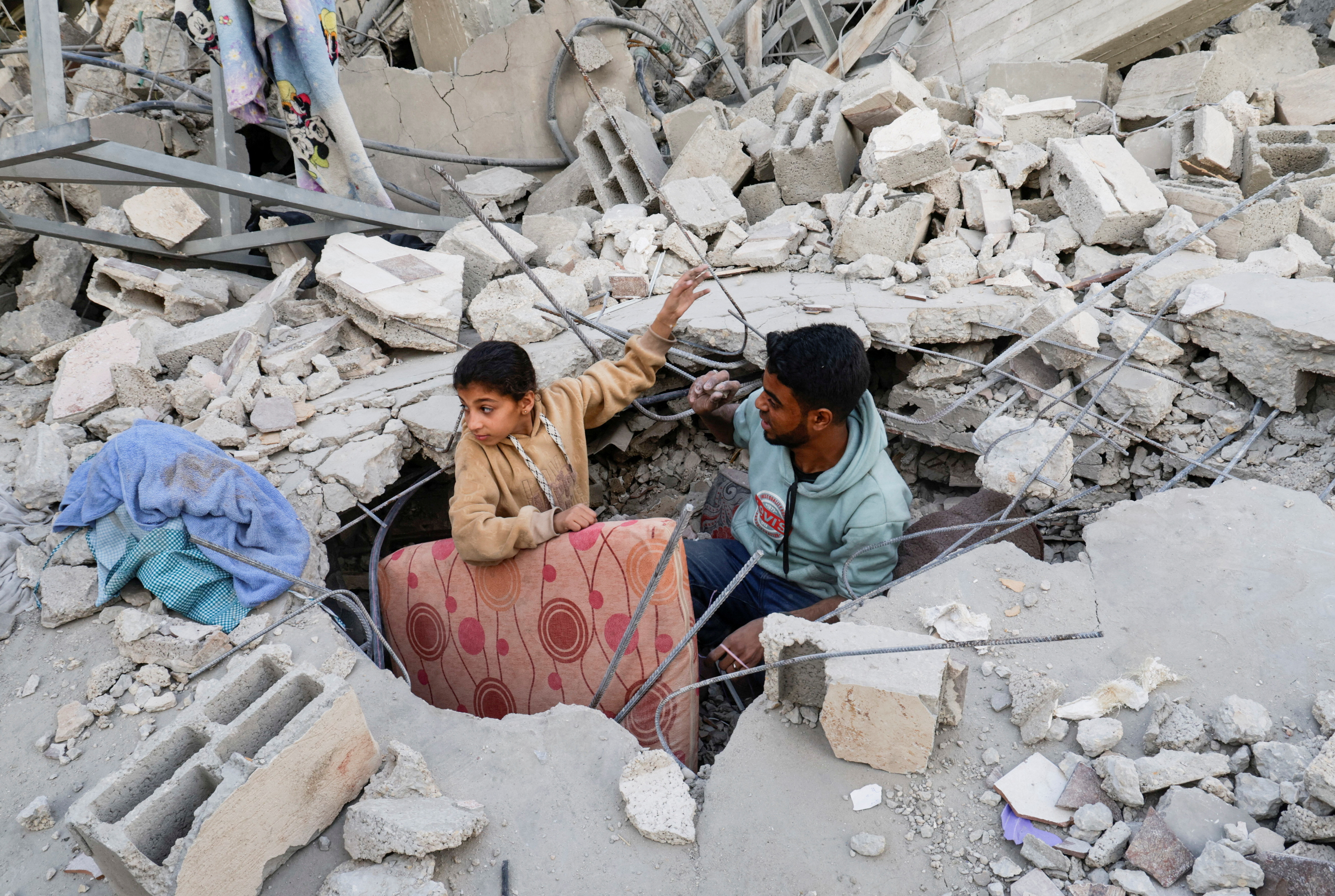Palestinians inspect the site of an Israeli strike on a house, in Khan Younis in the southern Gaza