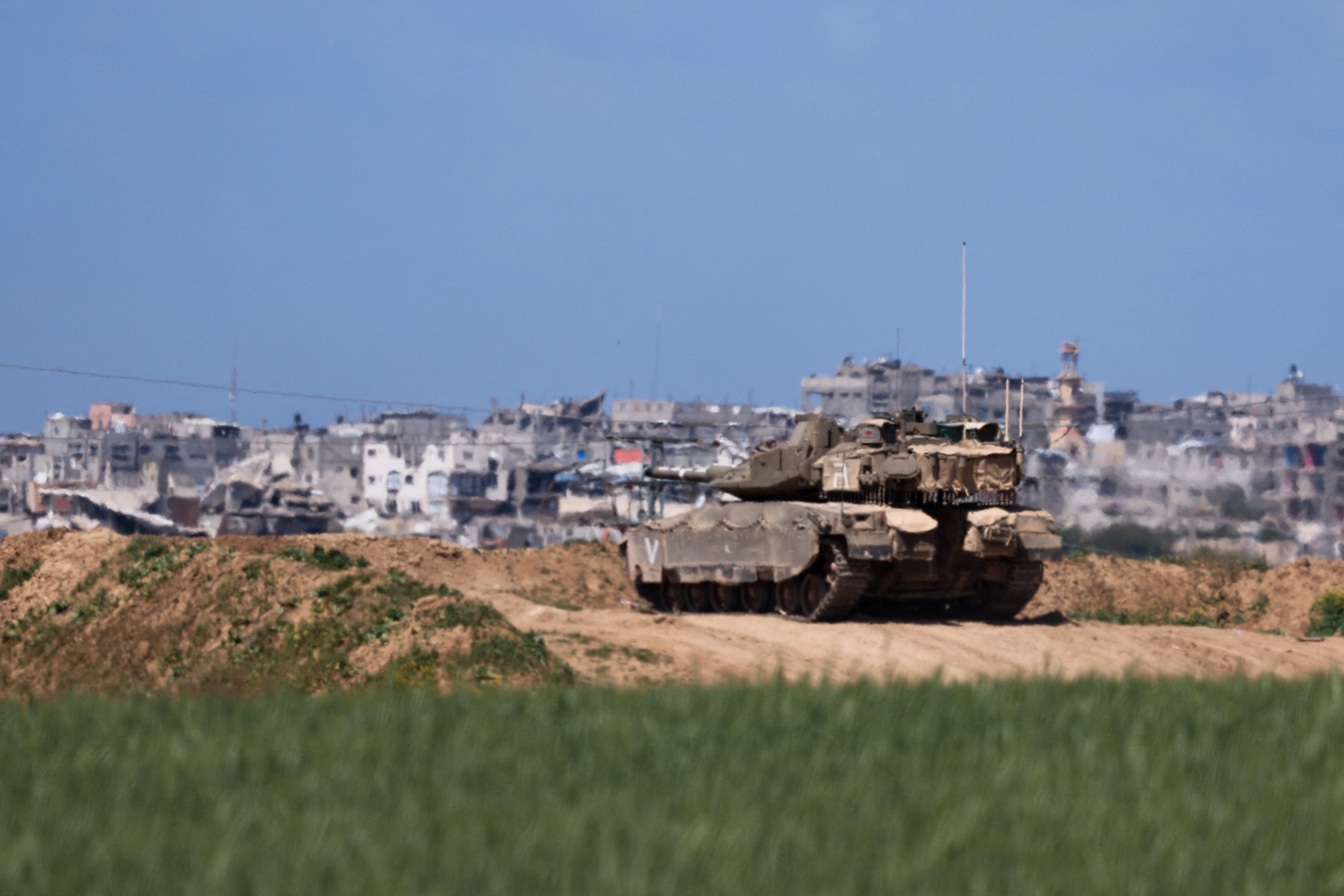 An Israeli military tank takes up position along Israel's southern border