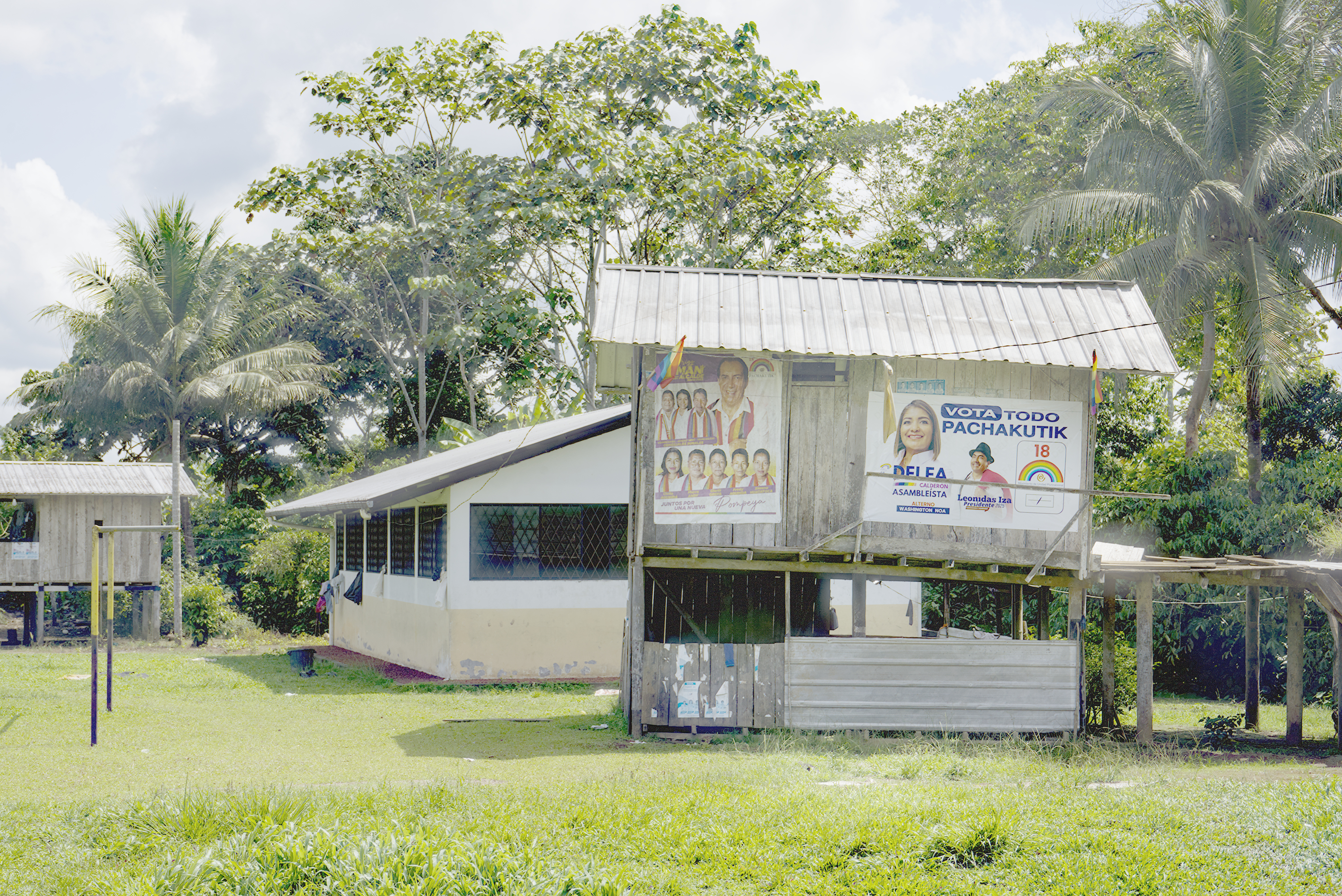 A sign in a verdant Ecuadorian landscape reads, "Vota todo Pachakutik"