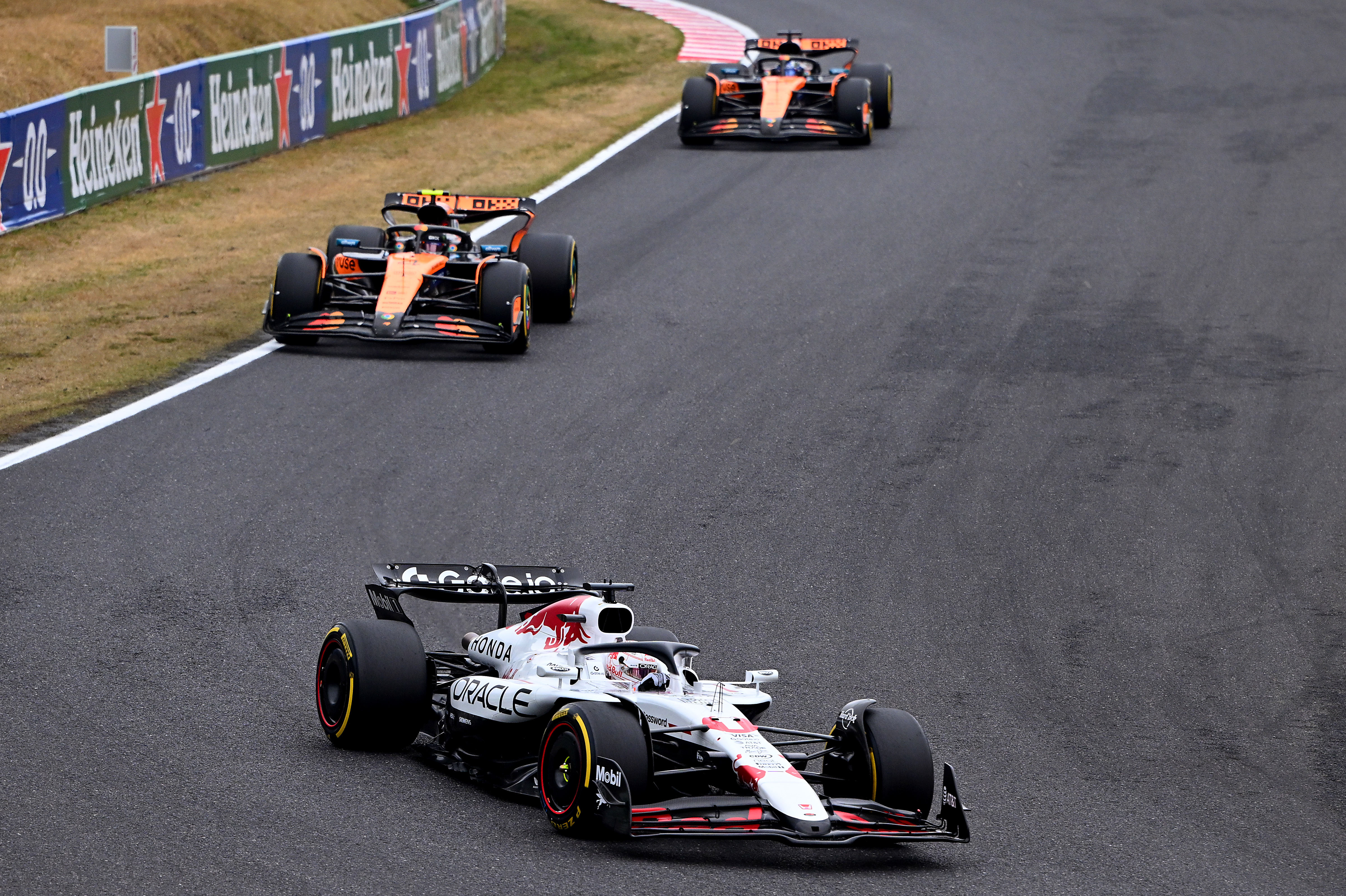 Red Bull’s Max Verstappen leads Lando Norris and Oscar Piastri of McLaren on track during the F1 Grand Prix of Japan at Suzuka Circuit on April 6, 2025, in Japan