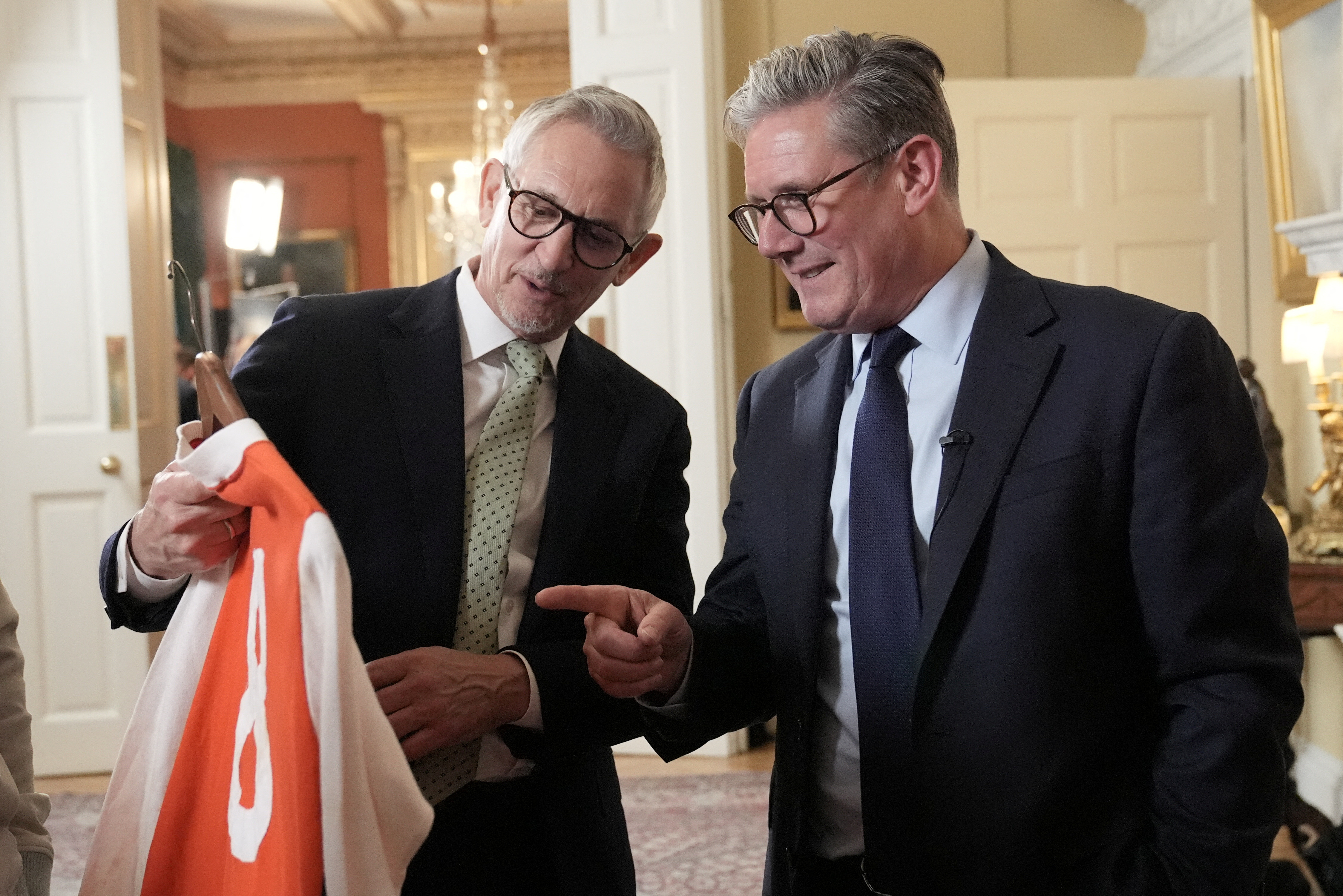 Gary Lineker, left, and Britain’s Prime Minister Keir Starmer look at a football shirt during a reception ahead of St George’s Day at 10 Downing Street, London, Britain on April 22, 2025