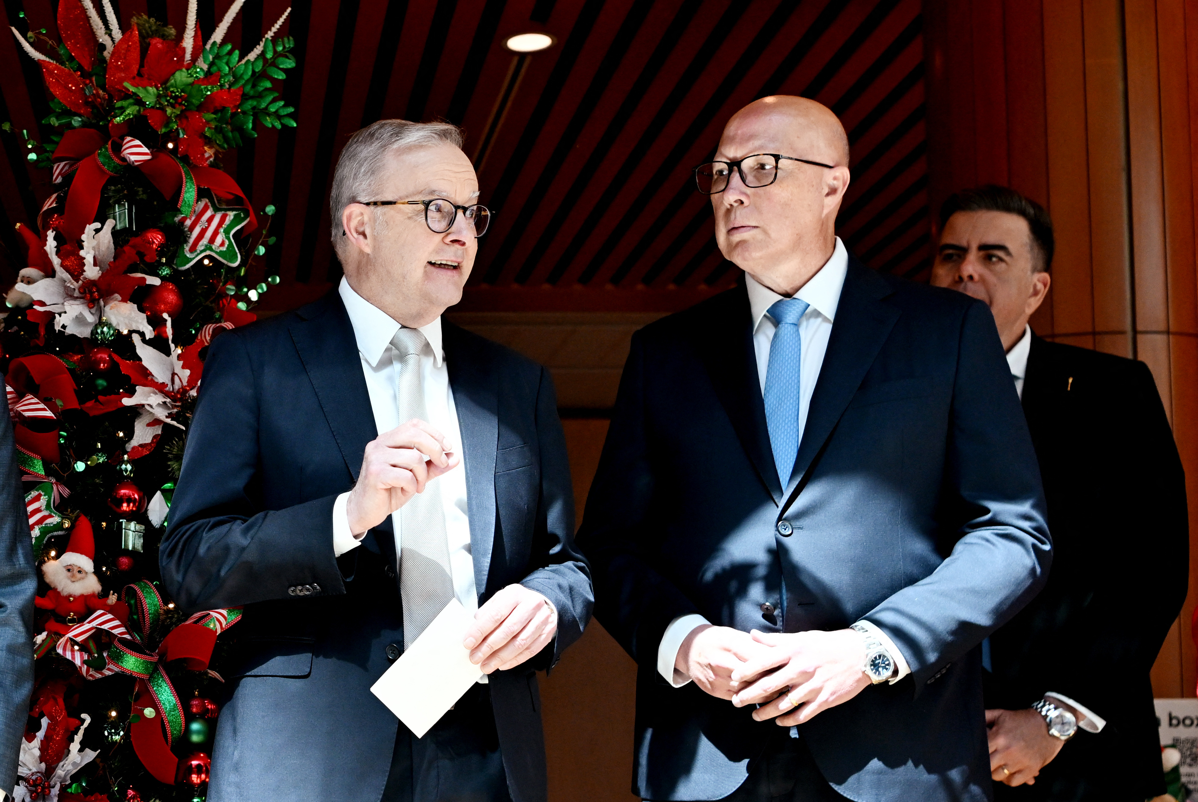 Australia’s Prime Minister Anthony Albanese (L) talks with Australia’s Opposition Leader Peter Dutton at the Wishing Tree at Parliament House in Canberra, on November 6, 2024