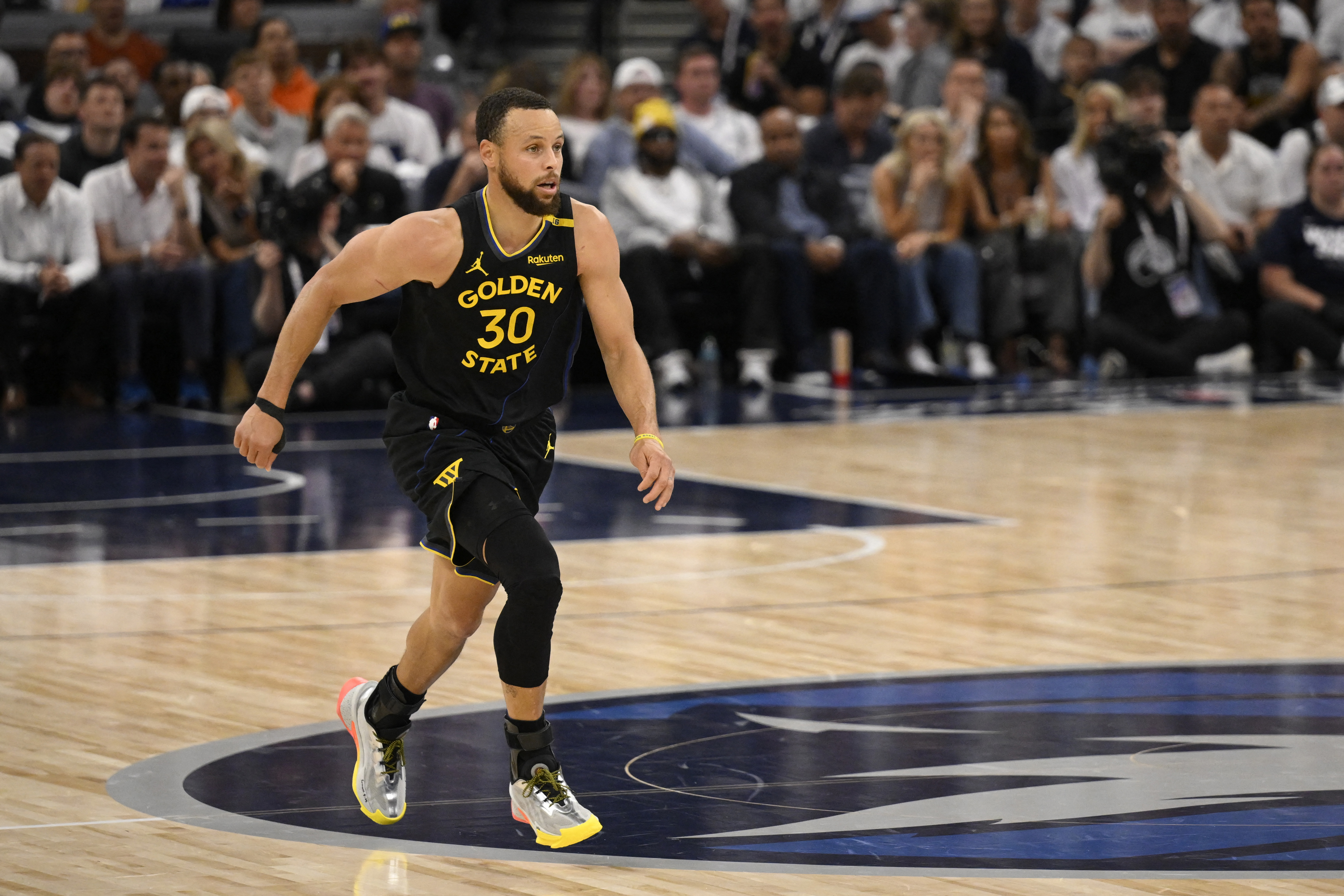 Stephen Curry #30 of the Golden State Warriors runs up the court in the second quarter after sustaining a leg injury