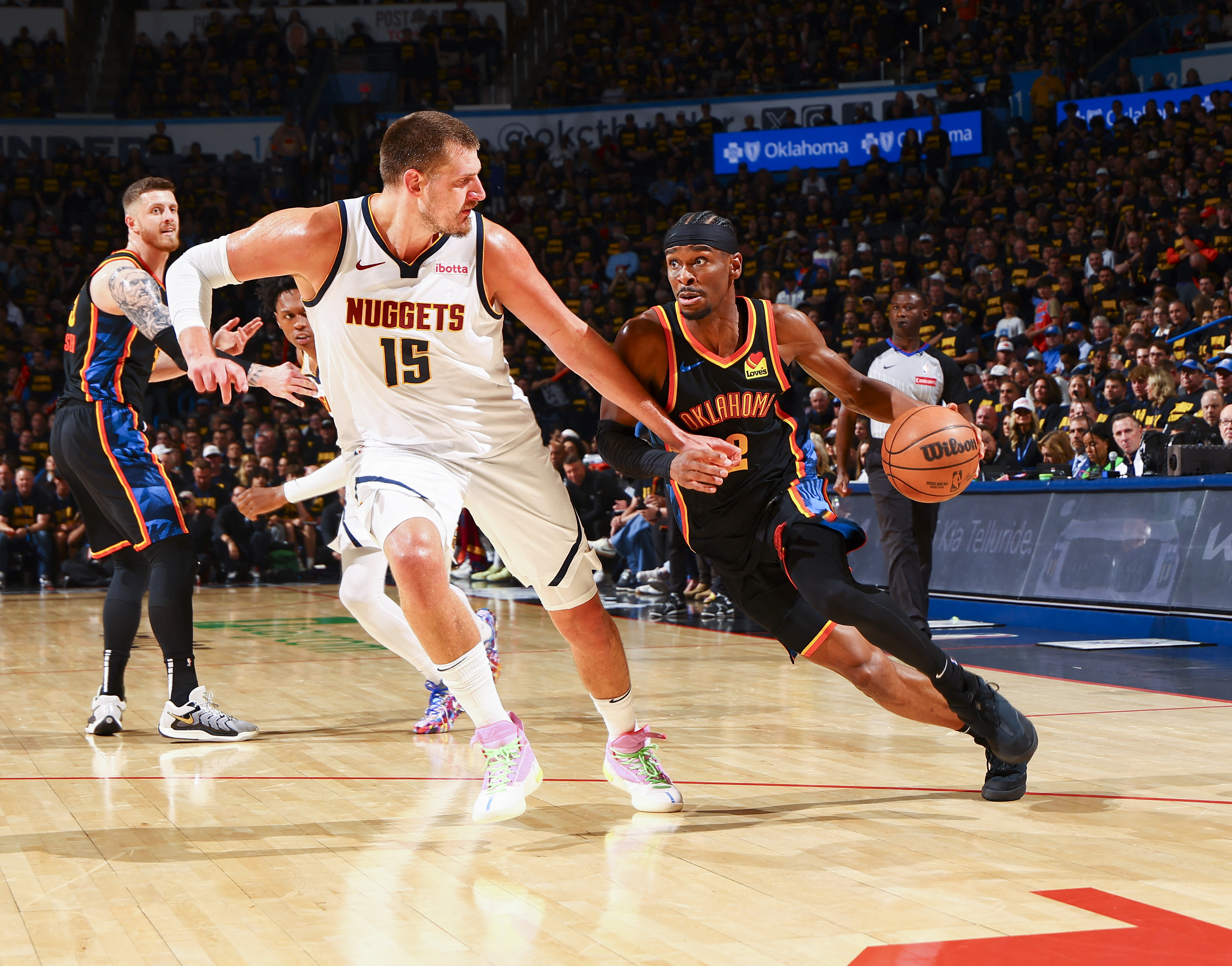 Shai Gilgeous-Alexander #2 of the Oklahoma City Thunder dribbles against Nikola Jokic #15 of the Denver Nuggets during Round 2, Game 2 of the 2025 NBA Playoffs on May 7, 2025 at Paycom Center in Oklahoma City, Oklahoma, US