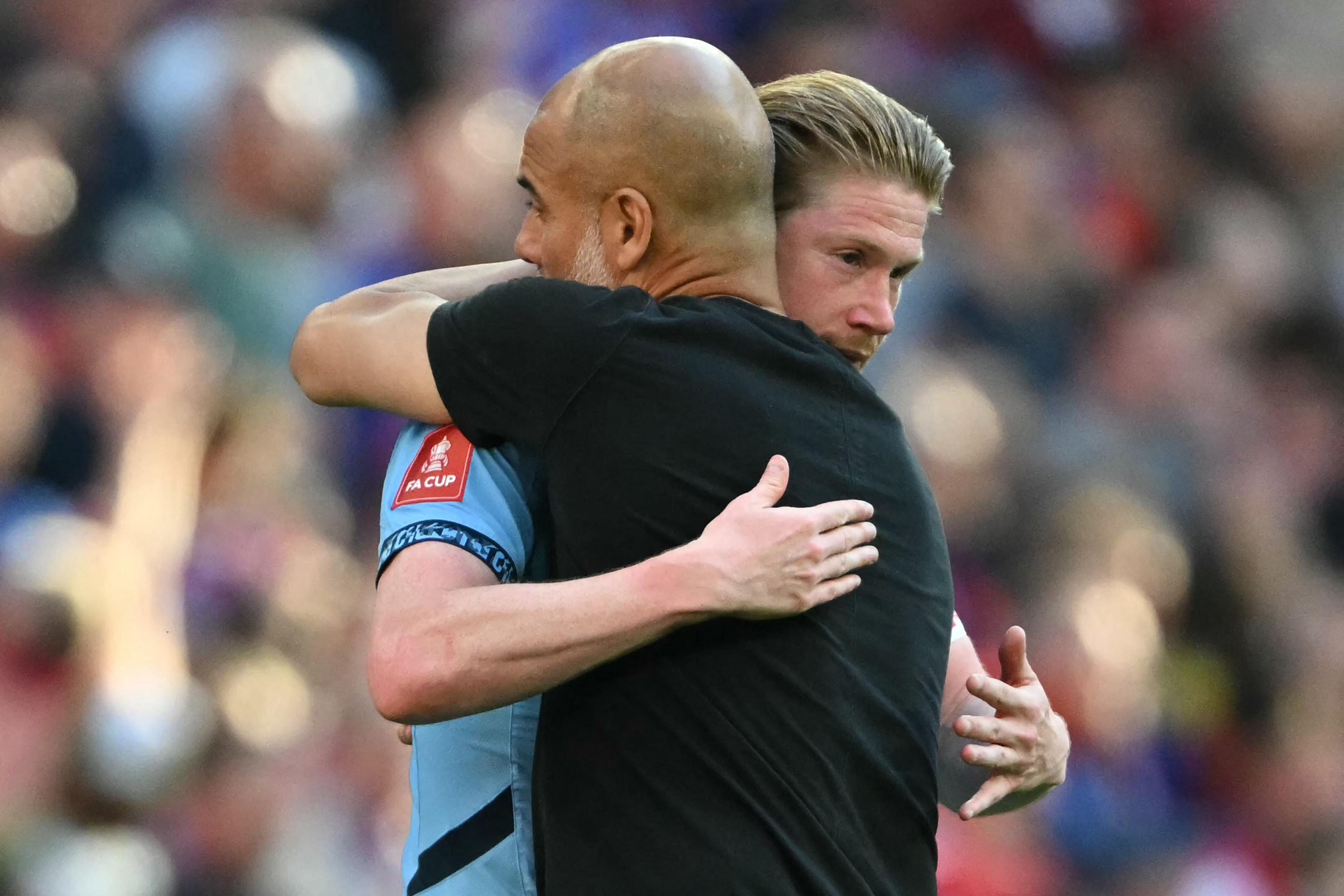 Manchester City’s manager Pep Guardiola, right, embraces De Bruyne after the match against Crystal Palace