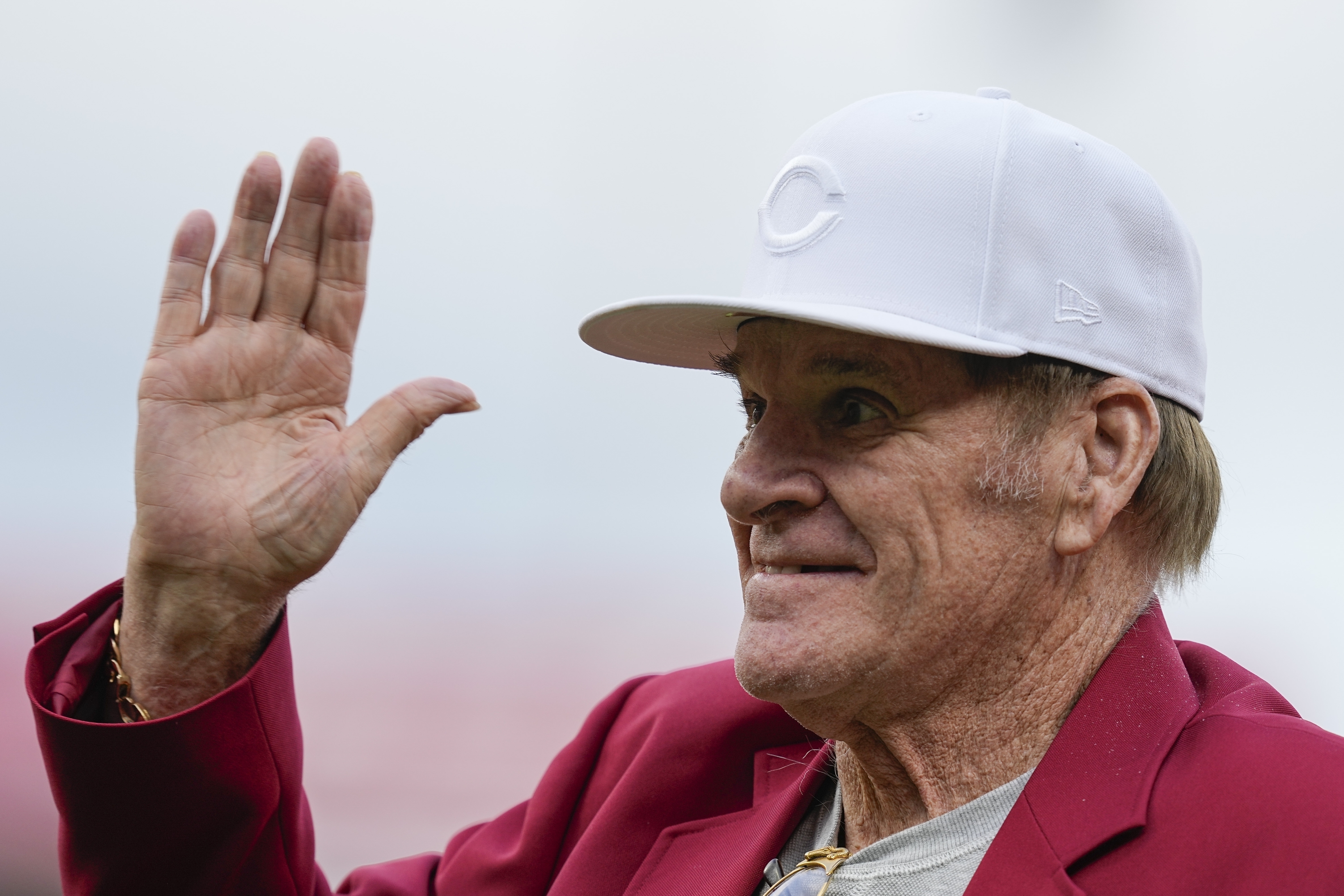 Former Cincinnati Reds player Pete Rose waves to fans during the Reds Hall of Fame induction ceremony on July 15, 2023, in Cincinnati, Ohio