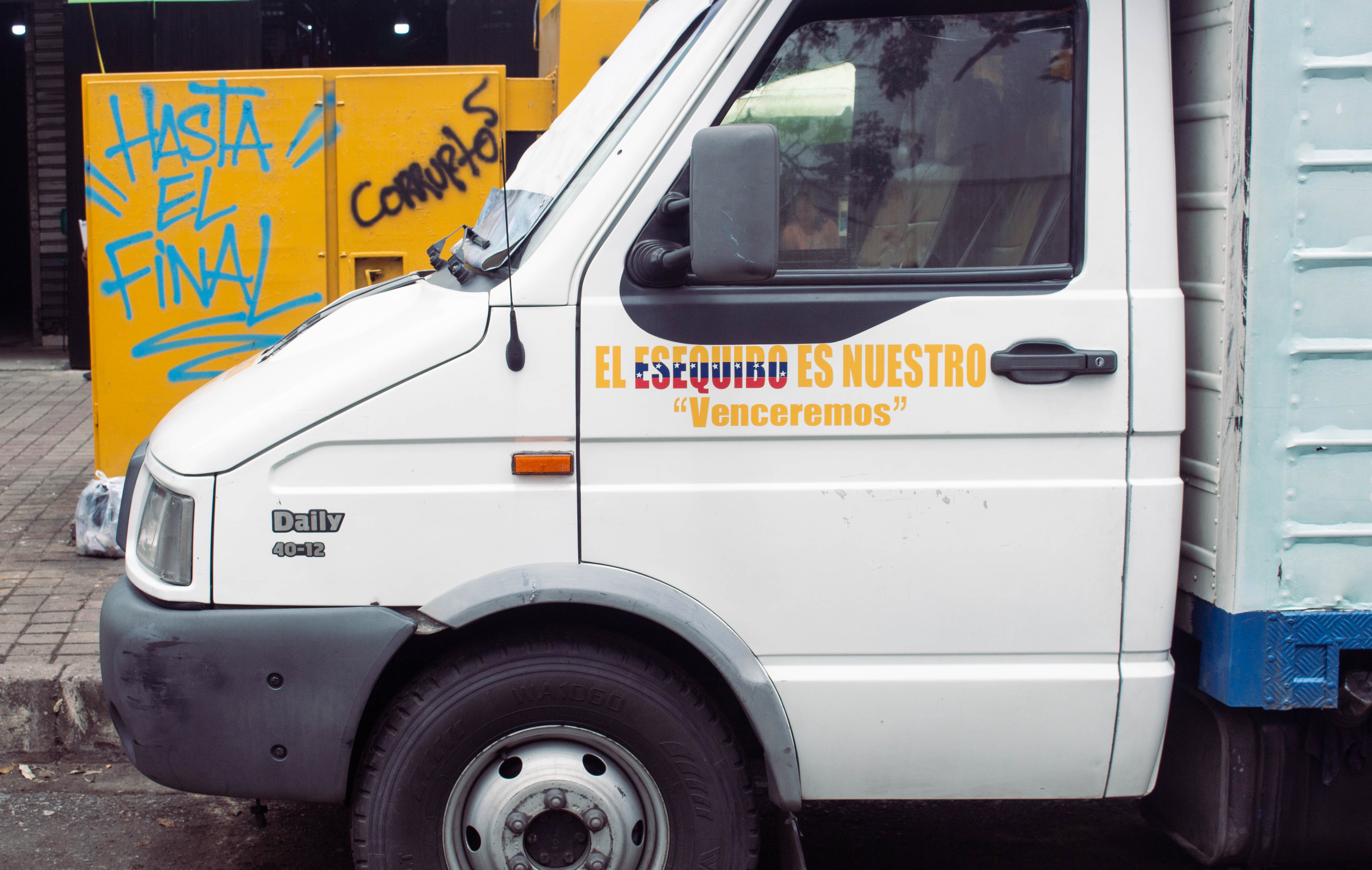 A sticker on the side of a truck says, 