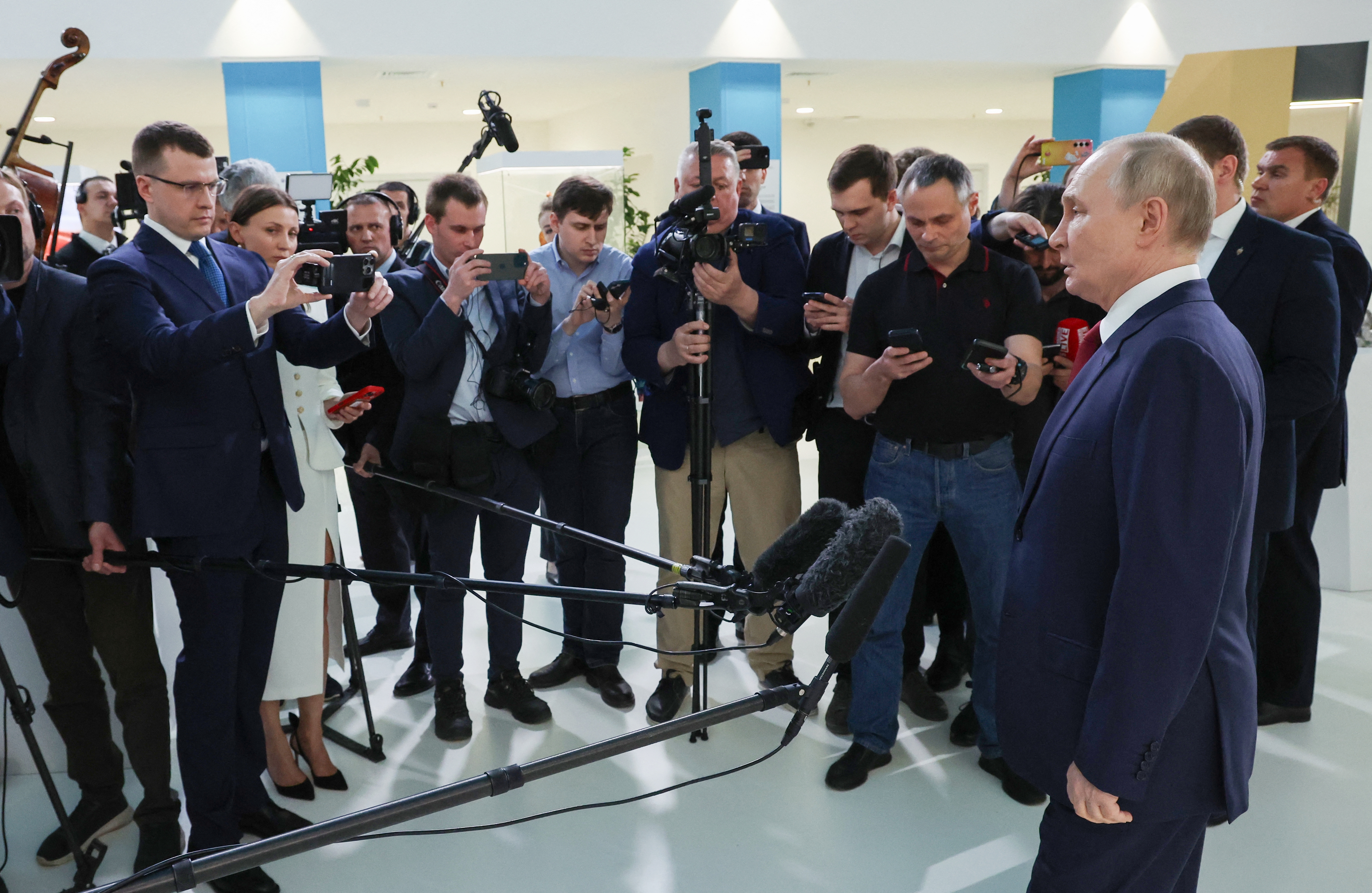 In this pool photograph distributed by the Russian state agency Sputnik, Russian President Vladimir Putin (R) speaks to journalists at the Sirius Educational Center in Sochi on May 19, 2025, after a telephone conversation with US President Donald Trump.