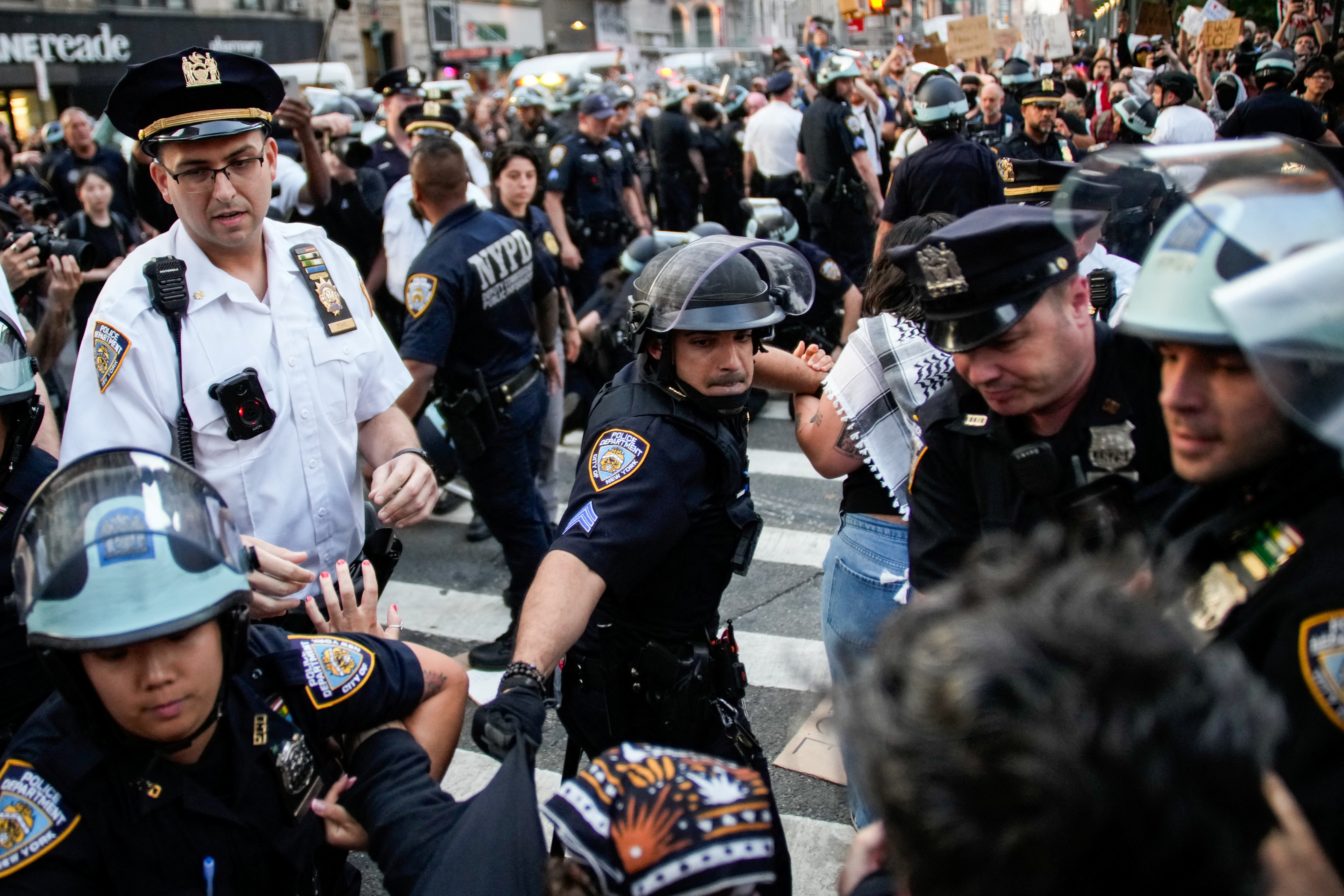 Law enforcement officers clash with demonstrators and detain them during a protest against federal immigration sweeps next to the US immigration court at the Jacob K Javits Federal Building in New York City on June 11, 2025