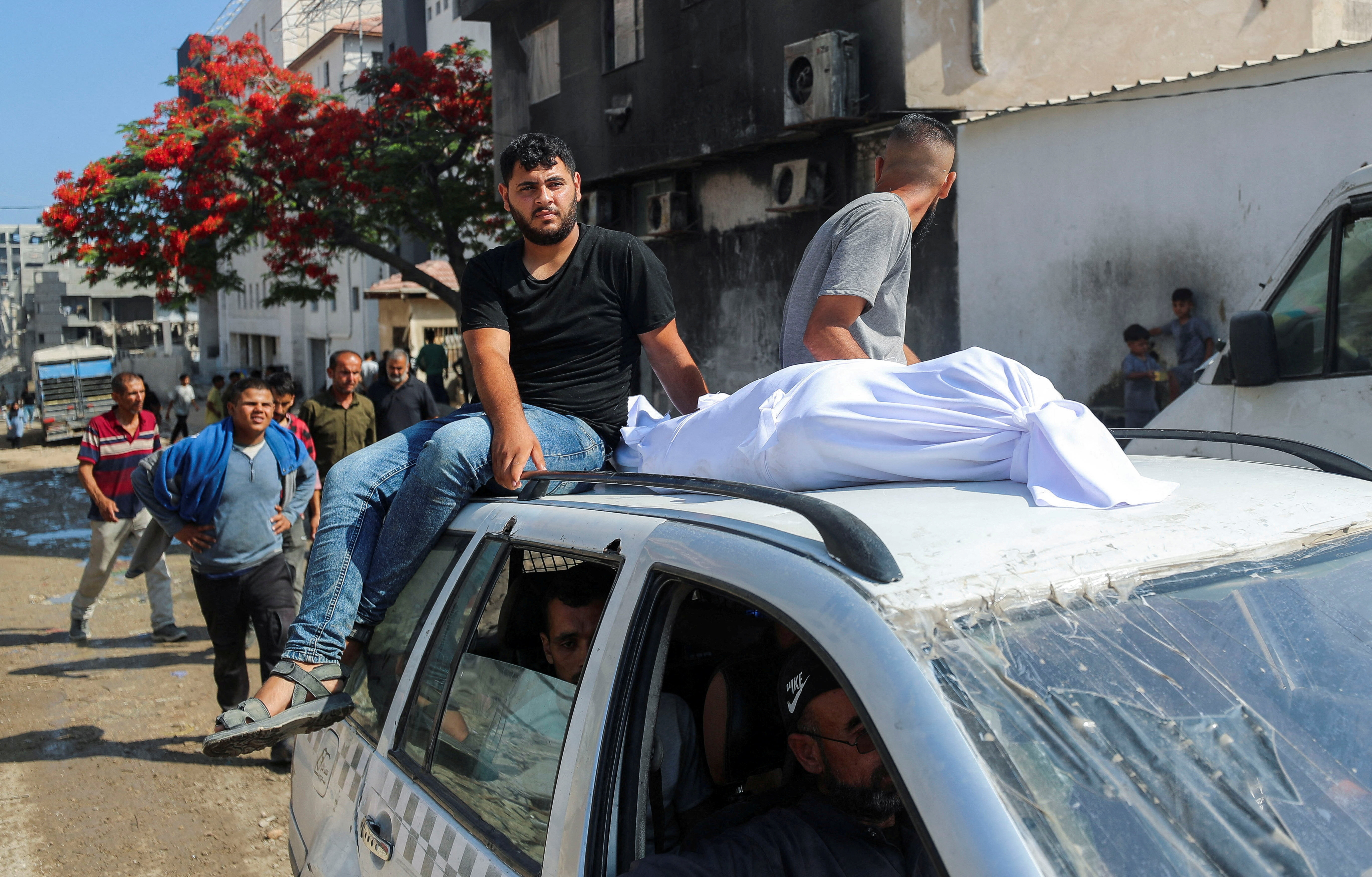 The body of a Palestinian is transported on a car as mourners attend the funeral of Palestinians who were killed, according to medics, in Israeli fire, at Al-Shifa hospital, in Gaza City, June 12, 2025. REUTERS/Mahmoud Issa TPX IMAGES OF THE DAY