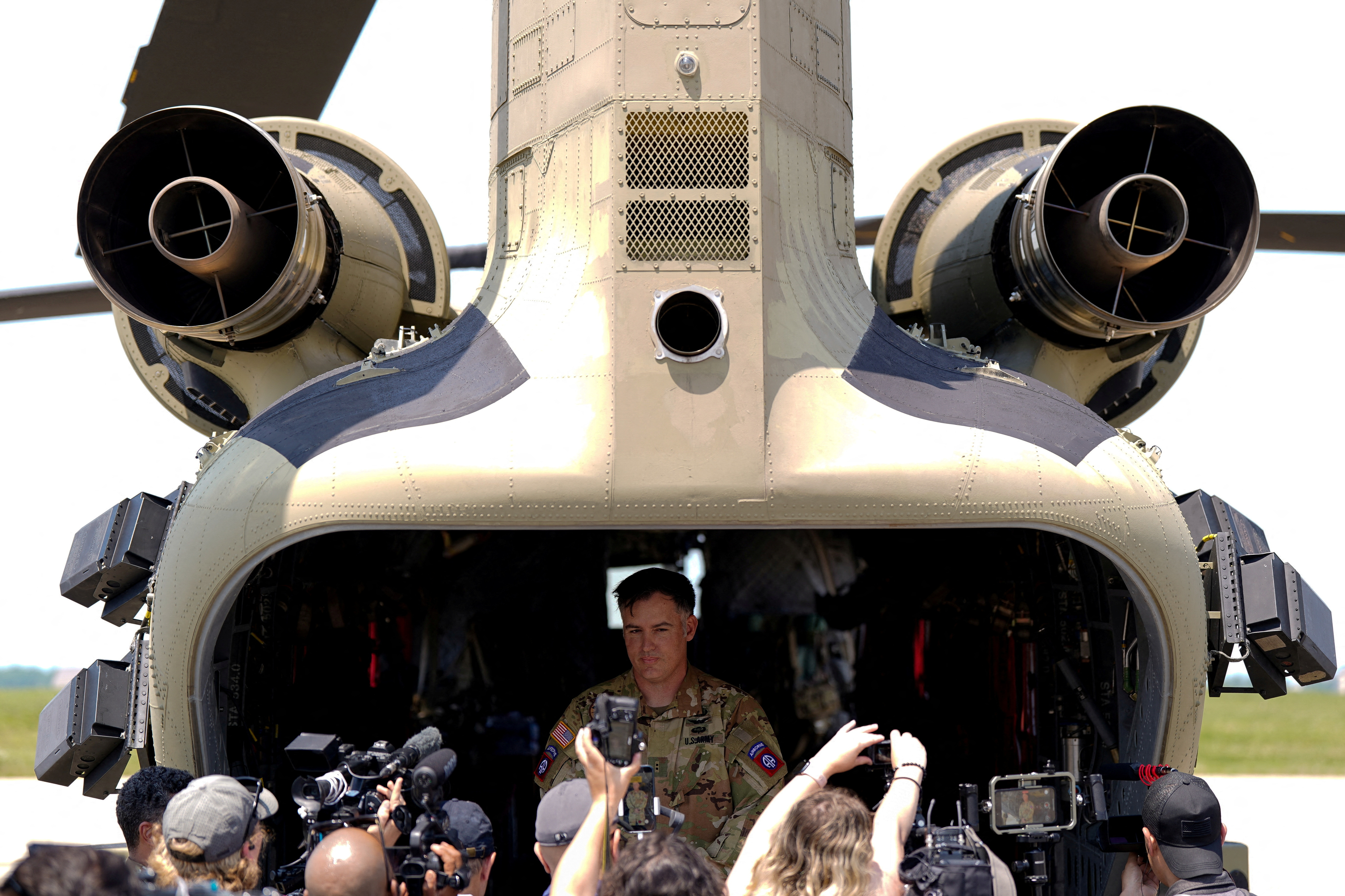 A military personnel stands next to a CH-47 Chinook, ahead of the U.S. Army's 250th Birthday Festival and Parade in Washington on June 14, at Joint Base Andrews, Maryland,