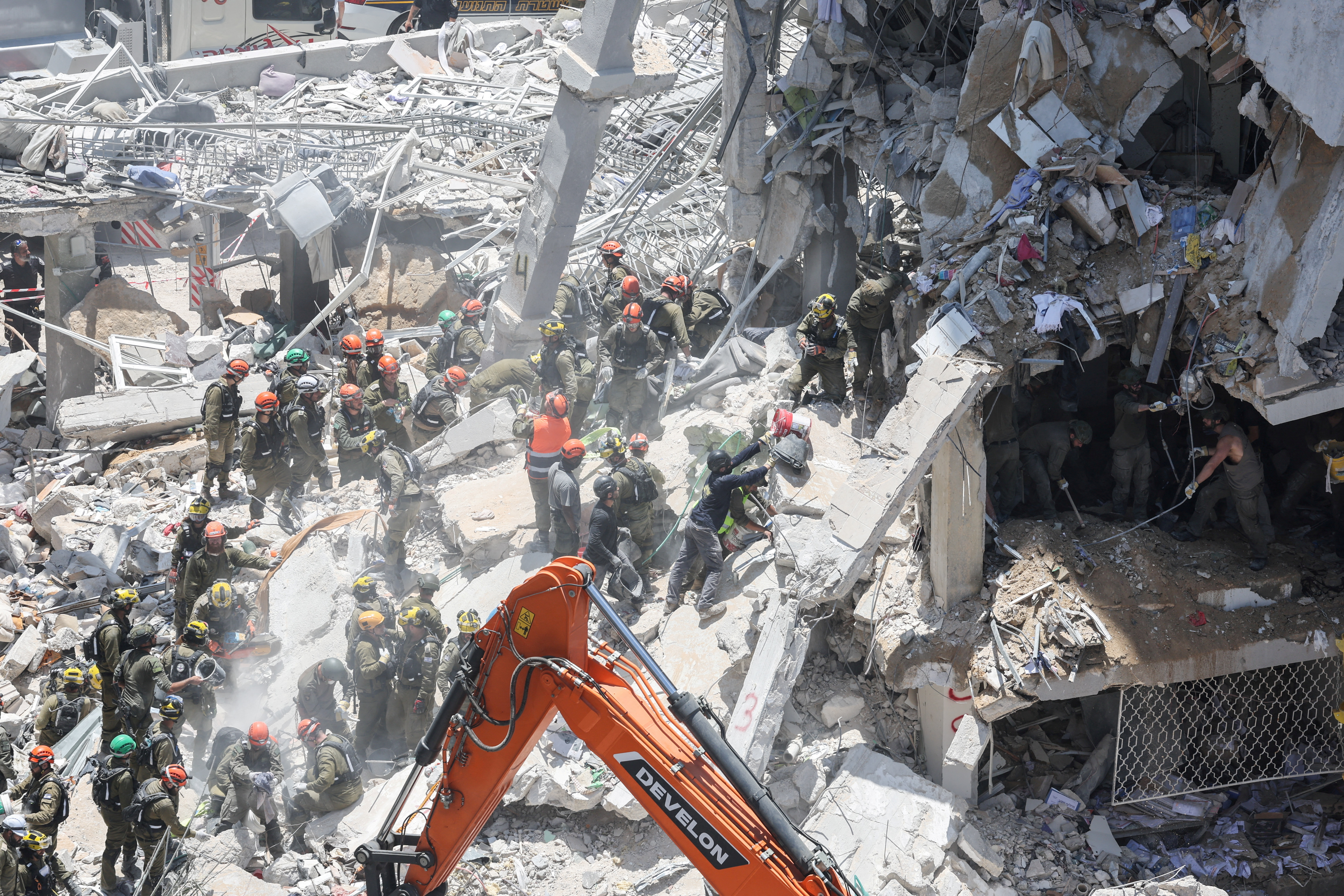 Rescue personnel work at an impact site following a missile attack from Iran, in Bat Yam, Israel, June 15, 2025. REUTERS/Ronen Zvulun TPX IMAGES OF THE DAY