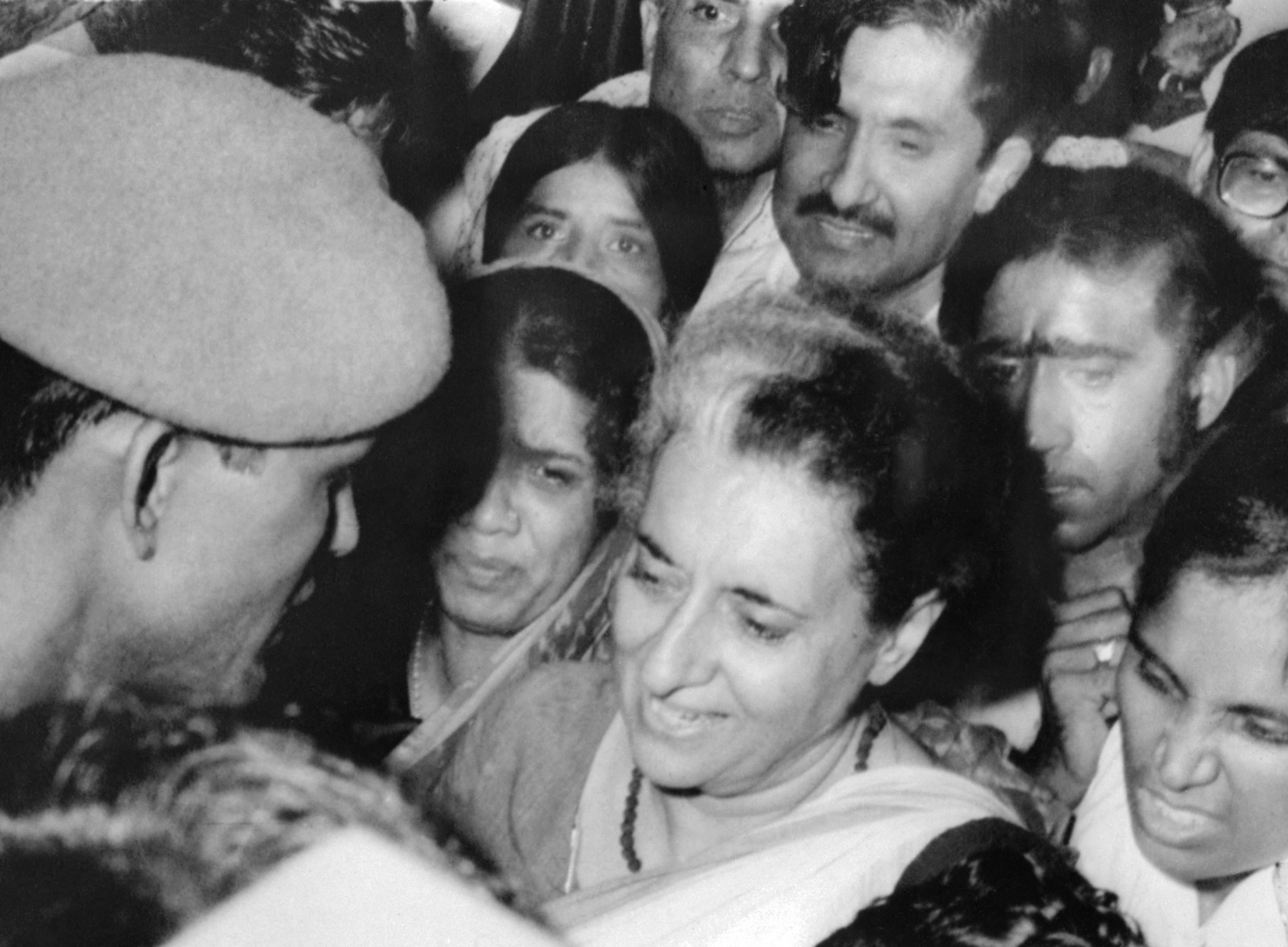India's ex-Prime Minister Indira Gandhi is surrounded by policemen and supporters as she leaves her residence in New Delhi to be taken into custody 10 March 1977. Indira Gandhi has been arrested for "misusing her social position". (Photo by AFP)