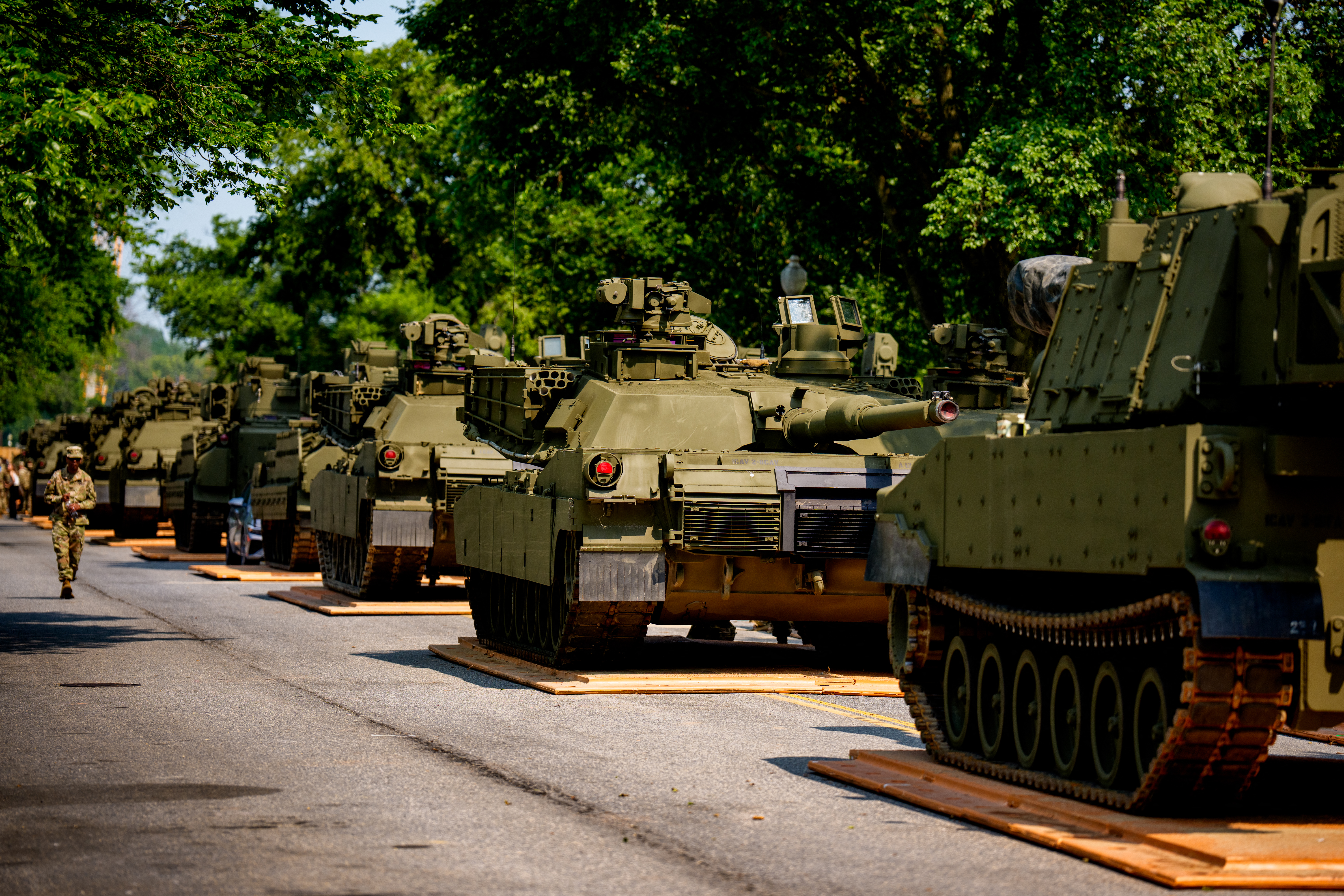 US Army soldiers work on an assortment of M1 Alpha a3 Abrams tanks, Stryker armoured vehicles, and M2 Bradley fighting vehicles at West Potomac Park along the Potomac River on June 11, 2025 in Washington, DC