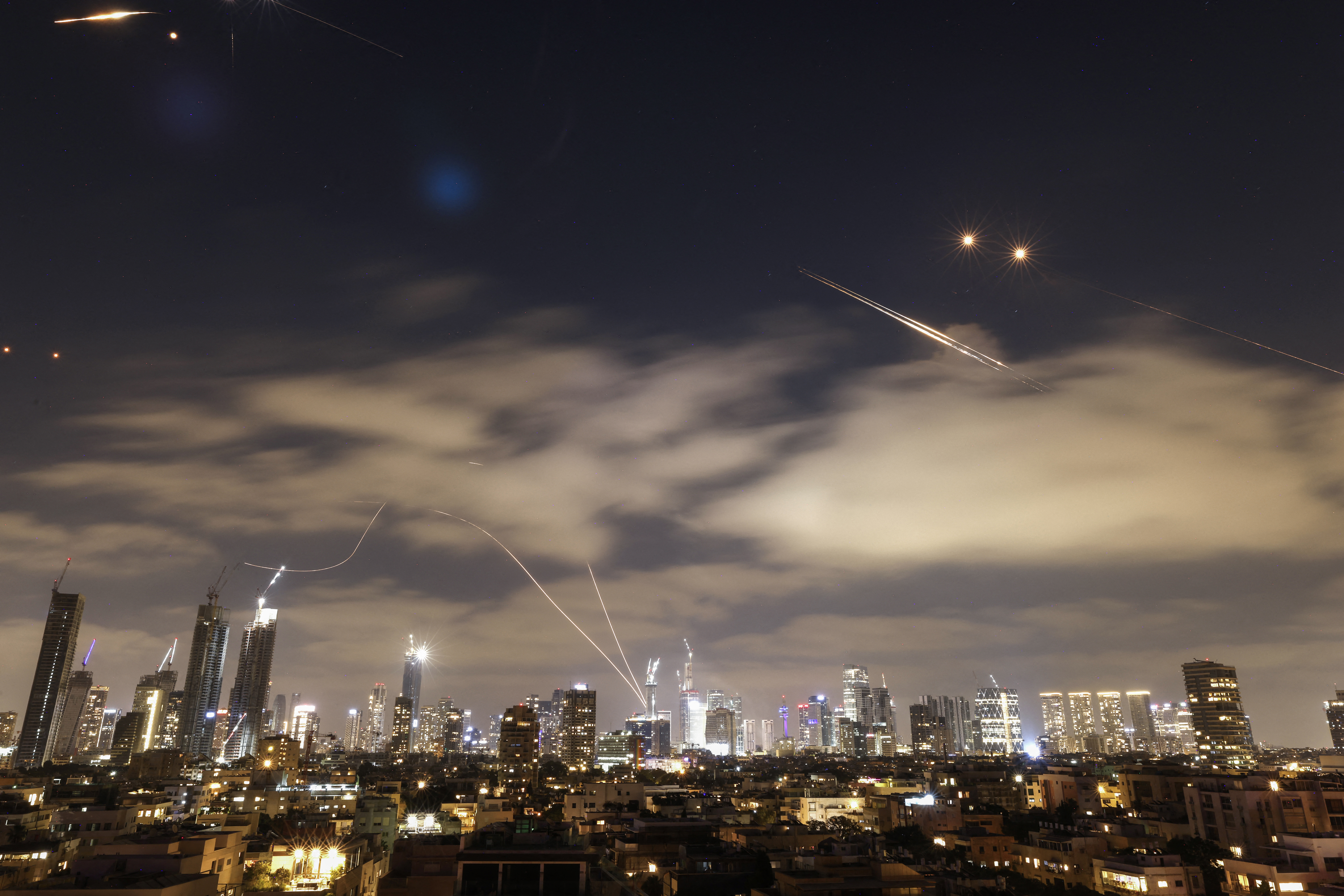 Israeli air defence systems are activated to intercept Iranian missiles over the Israeli city of Tel Aviv