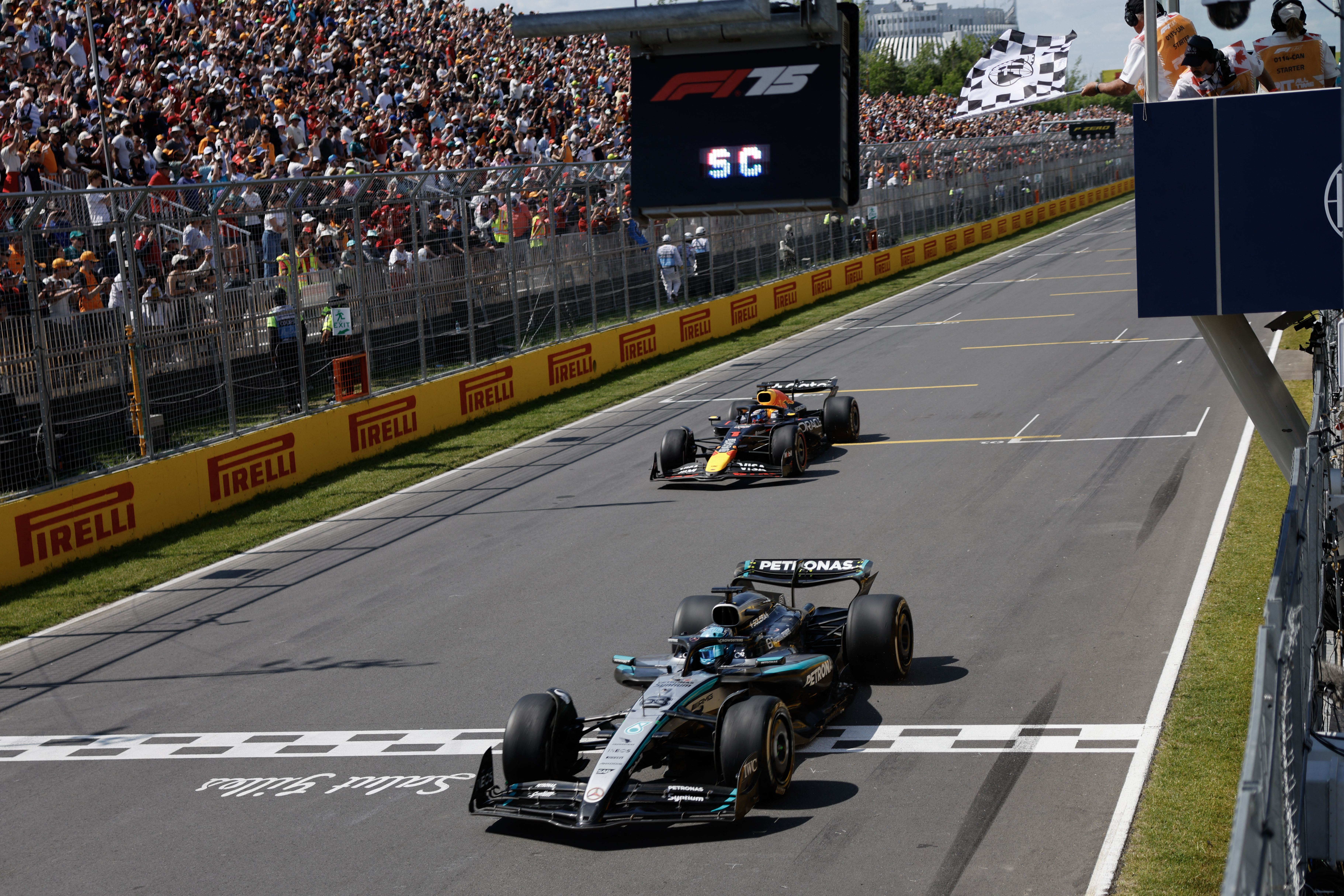 Mercedes’s George Russell, front, crosses the finish line to win the Canadian Grand Prix, followed by Red Bull Racing’s Max Verstappen in second place