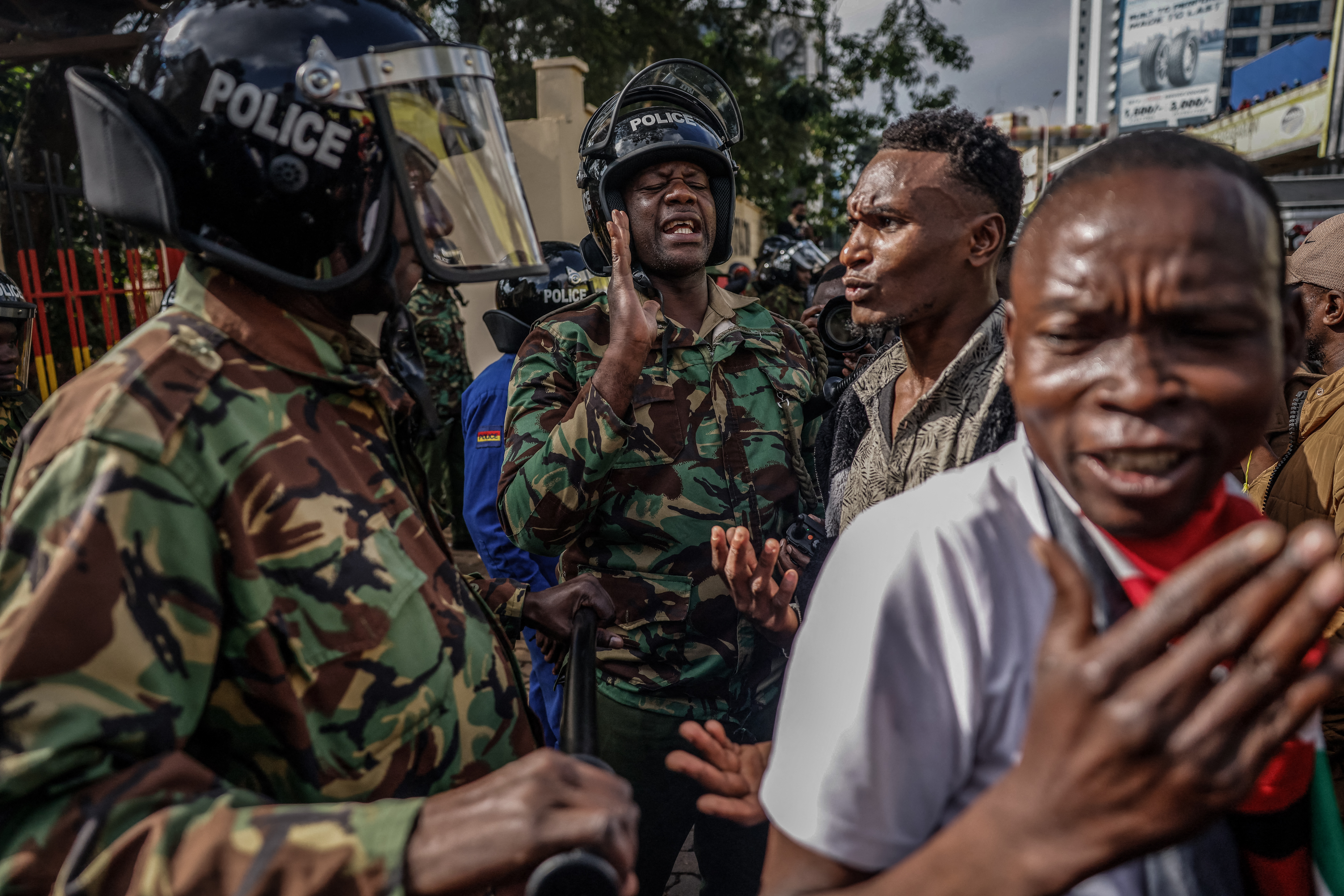 Kenya police interact with demonstrators marching in downtown Nairobi, Kenya