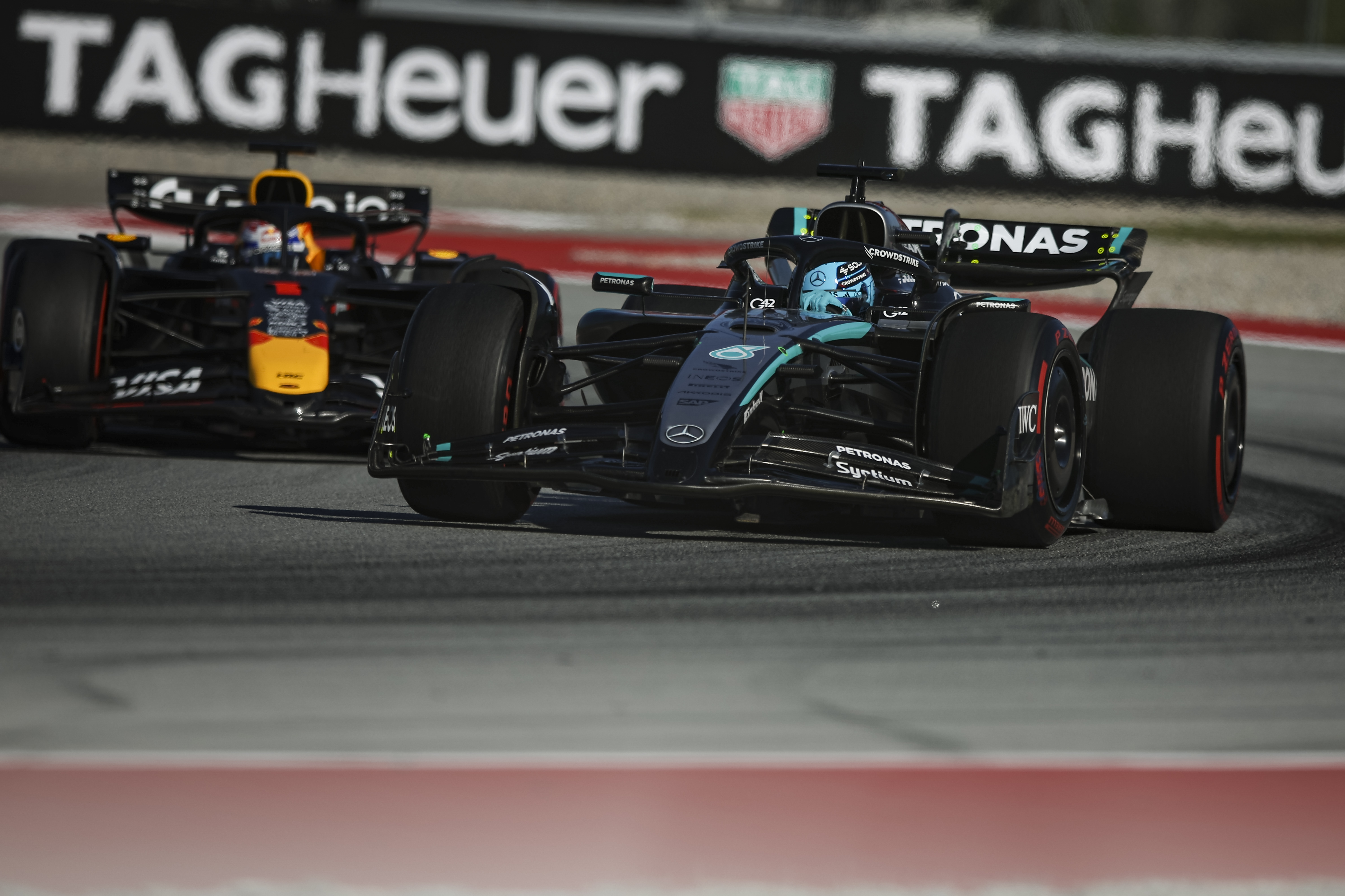 Max Verstappen and George Russell in action.