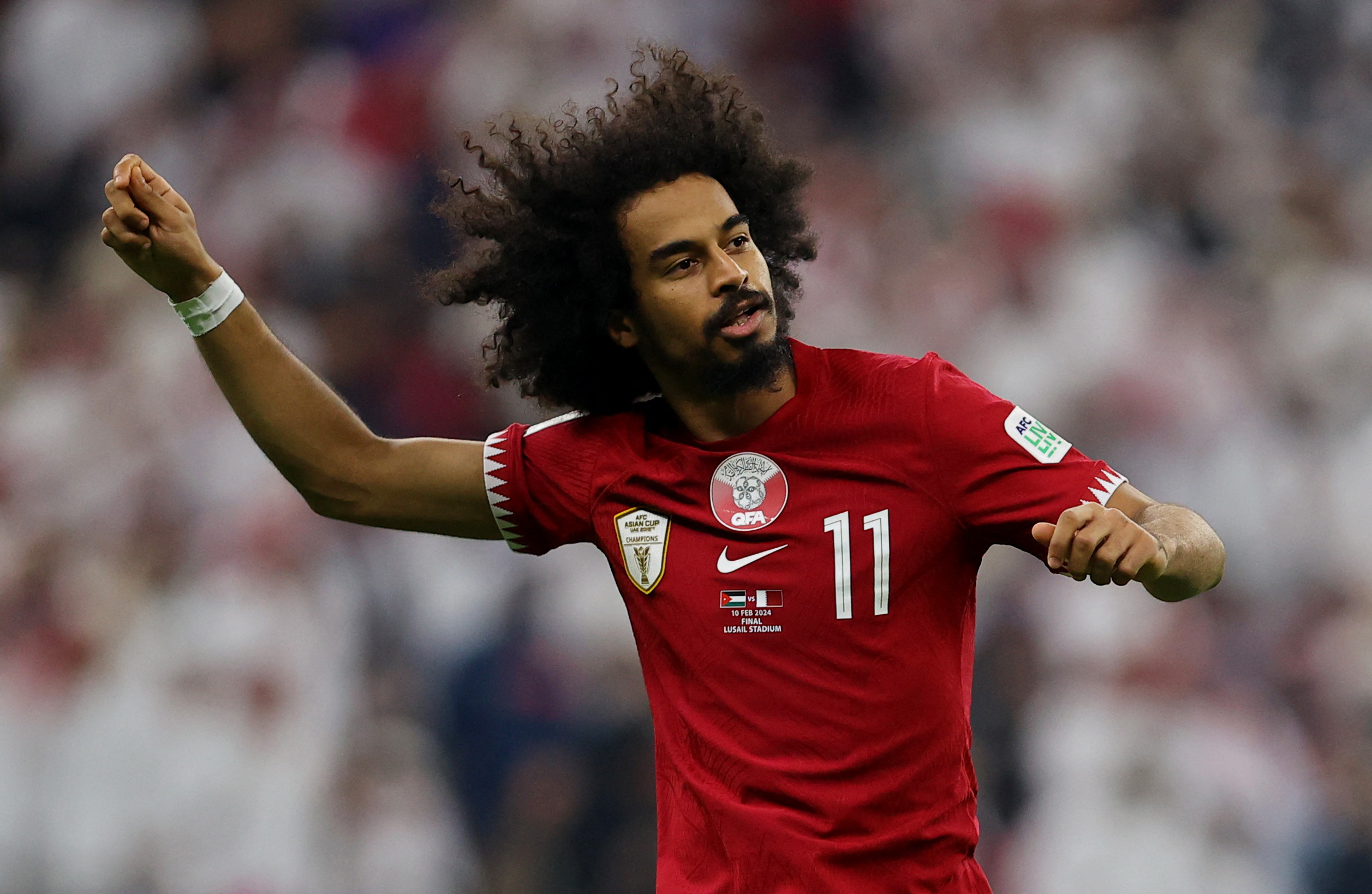 Qatar's Akram Afif celebrates scoring a goal.