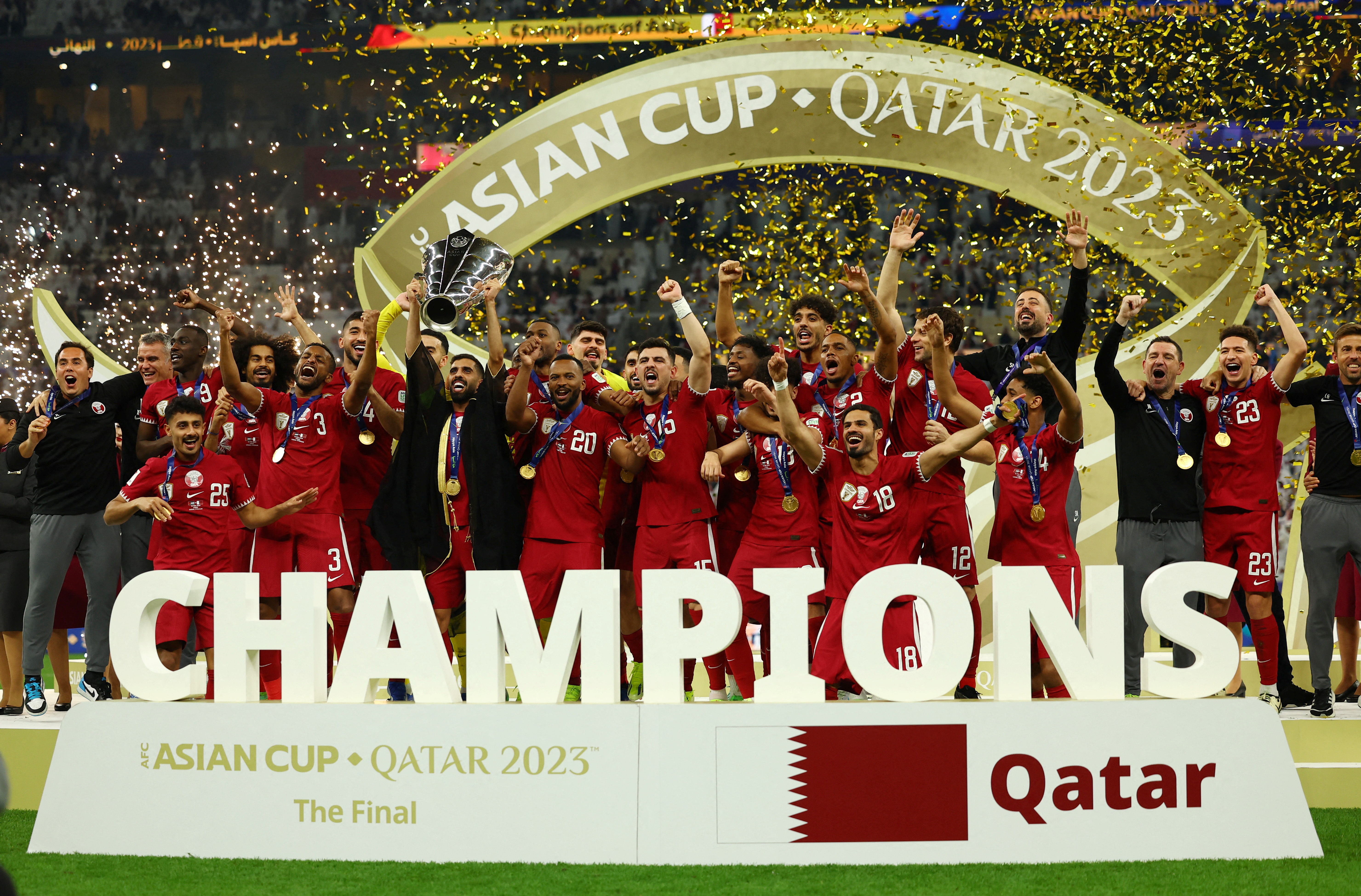 Hassan Al-Haydos lifts the 2023 AFC Asian Cup trophy with teammates after winning the title for a second successive time