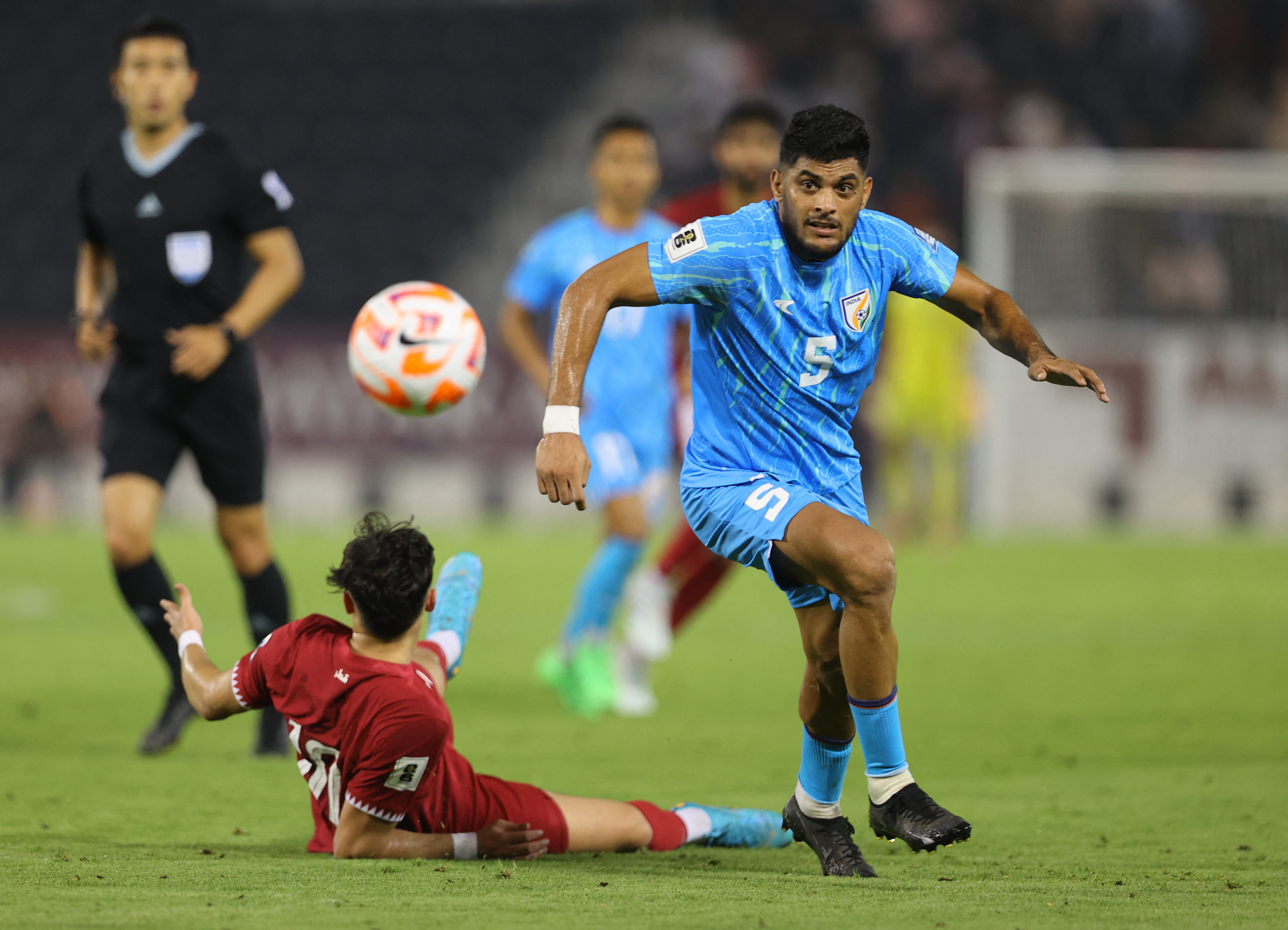 Football - World Cup - AFC Asian Qualifiers - Group A - Qatar v India - Jassim Bin Hamad Stadium, Doha, Qatar - June 11, 2024 India's Mehtab Singh in action with Qatar's Ahmed Alrawi