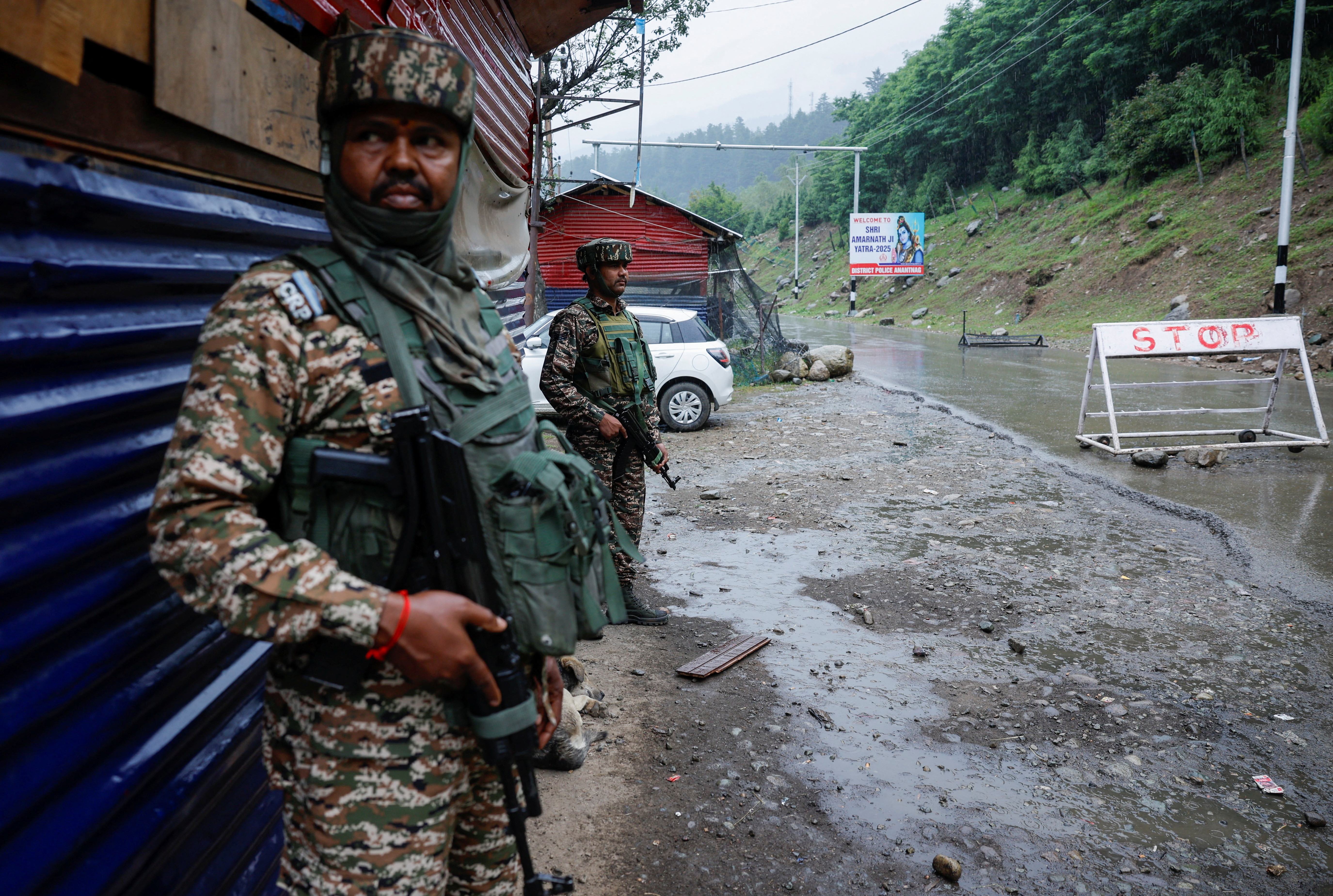 Indian security personnel stand guard on a road ahead of annual Hindu pilgrimage to Amarnath cave