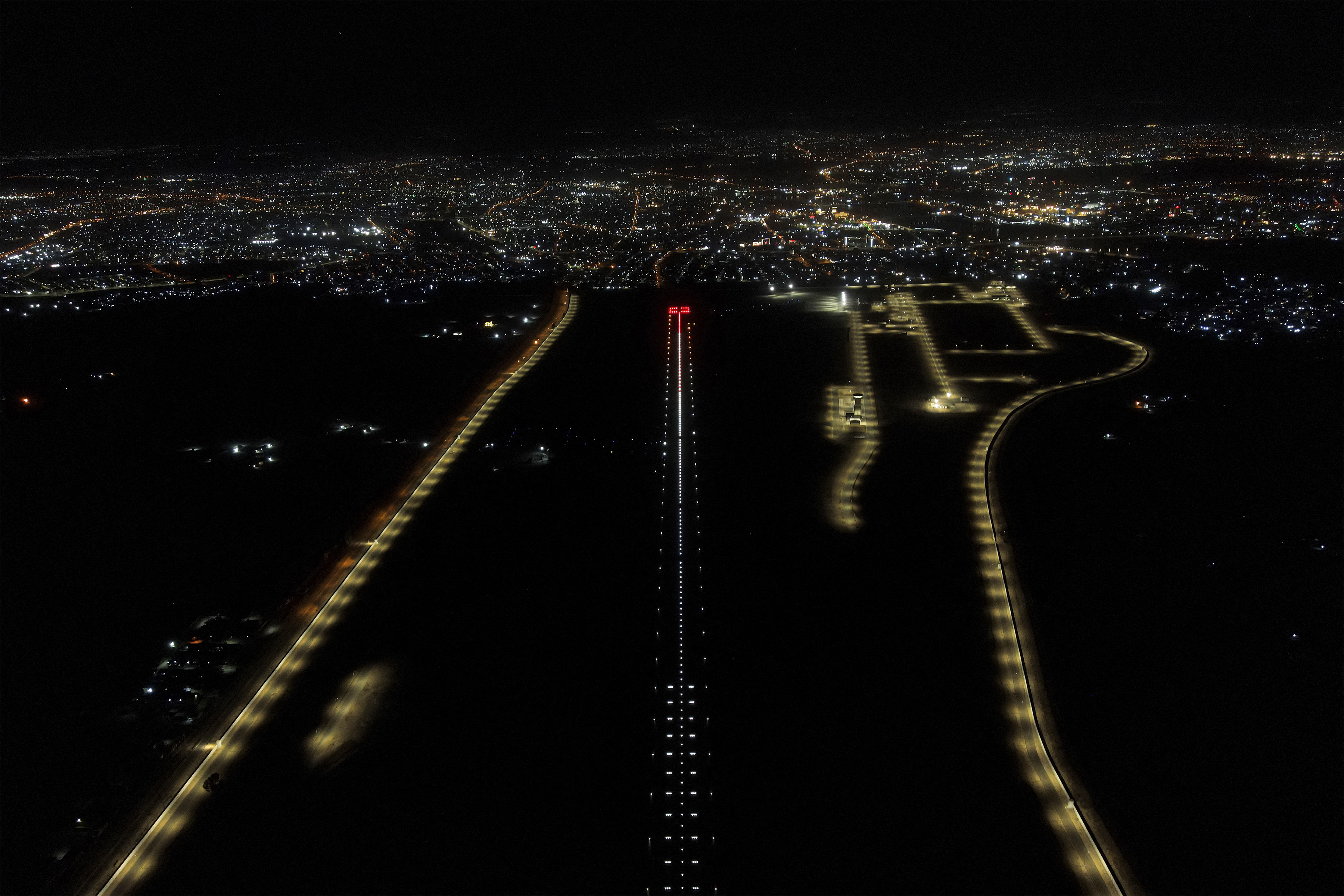 This aerial night-time view shows the runway of Mosul International Airport in northern Iraq before its official re-inauguration early on July 16, 2025.