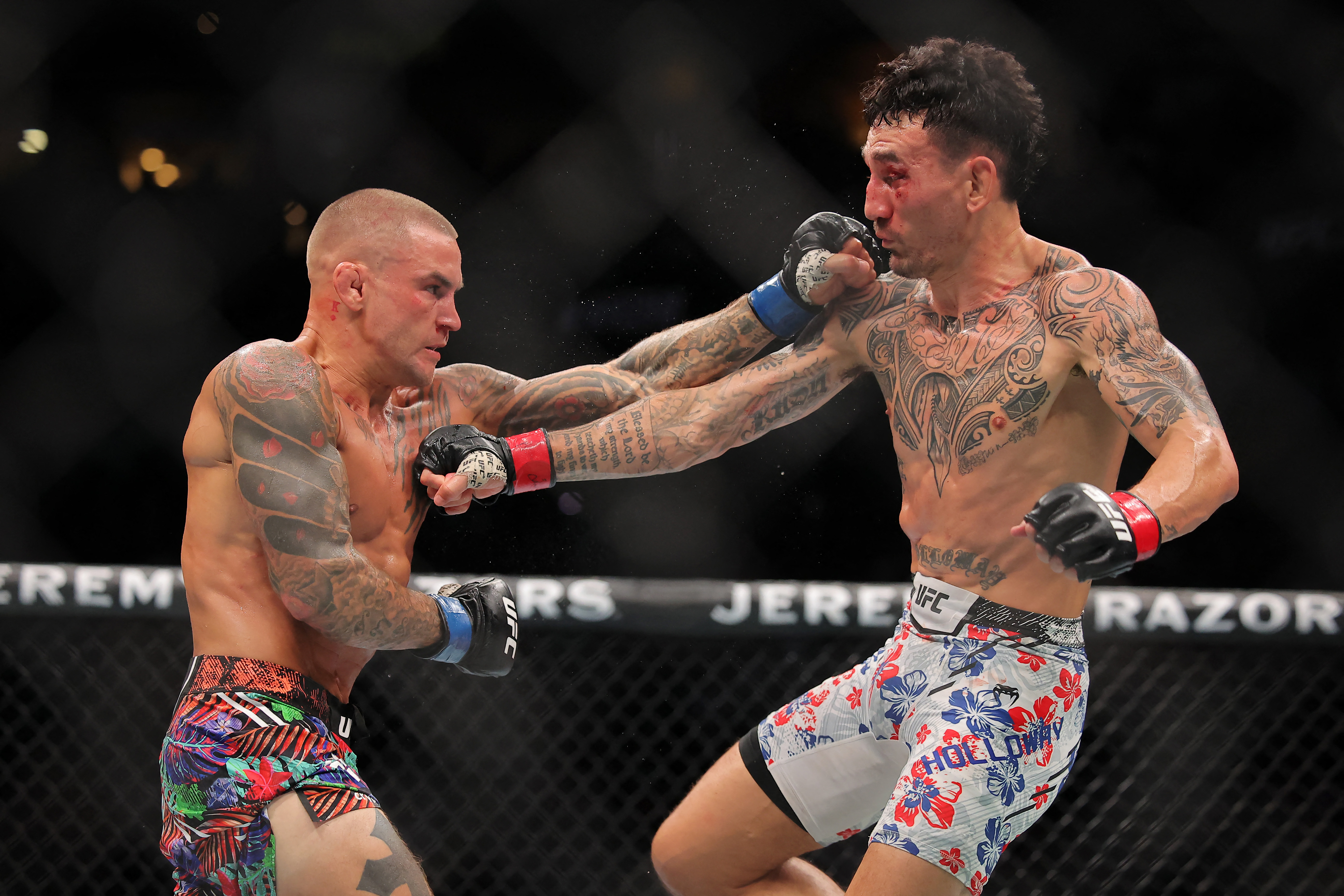 Dustin Poirier of the United States (L) and Max Holloway in action.