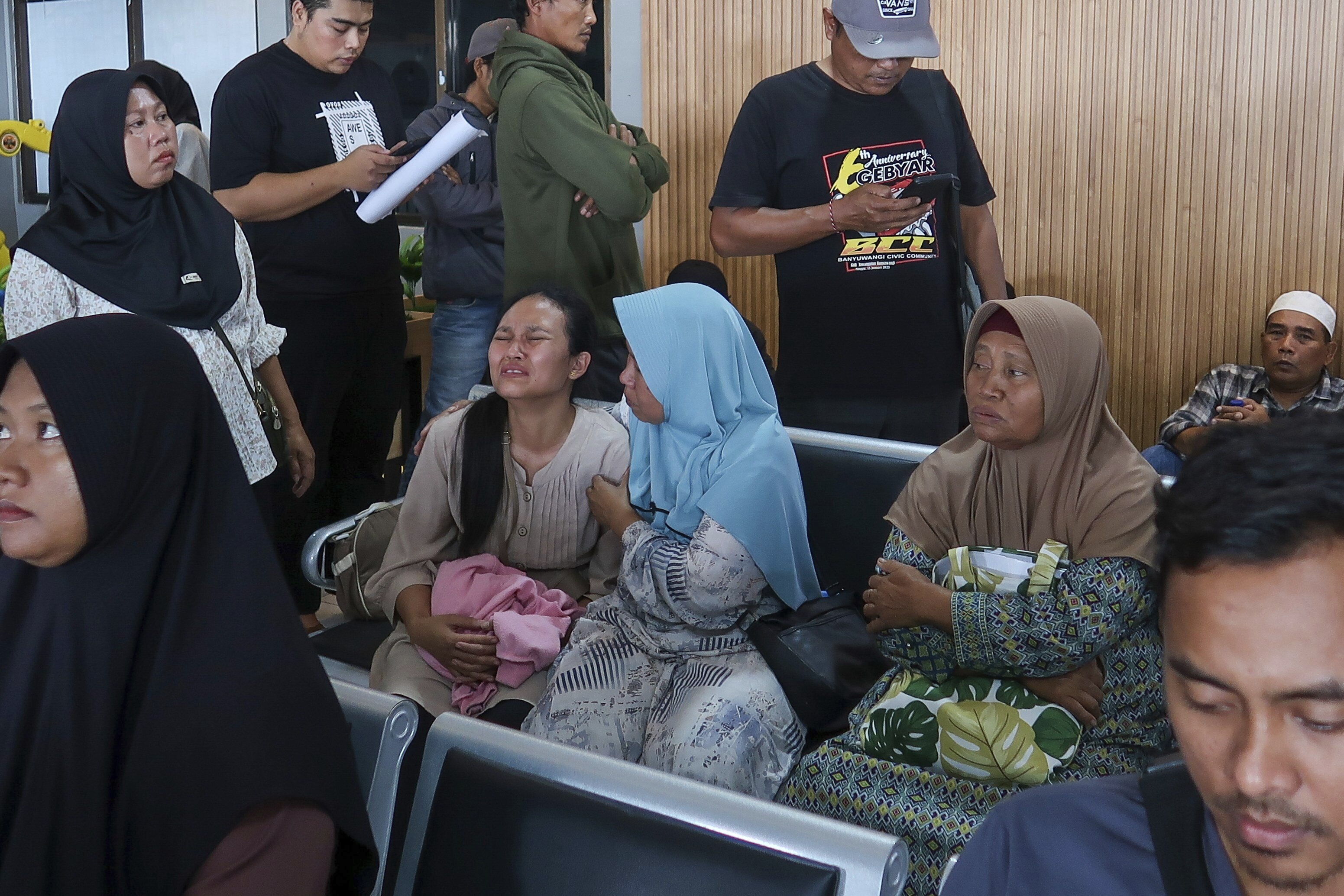 A passenger’s relative at the Port of Ketapang in Banyuwangi, East Java, weeps after a ferry carrying dozens of passengers sank near the resort island of Bali