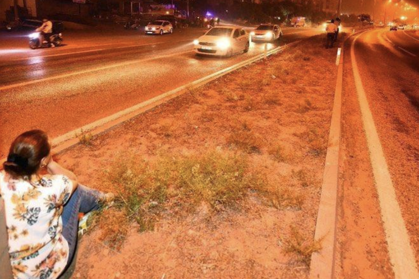Woman watching the flames in Serinyol neighborhood, Hata, Photo by Ethem Asker.