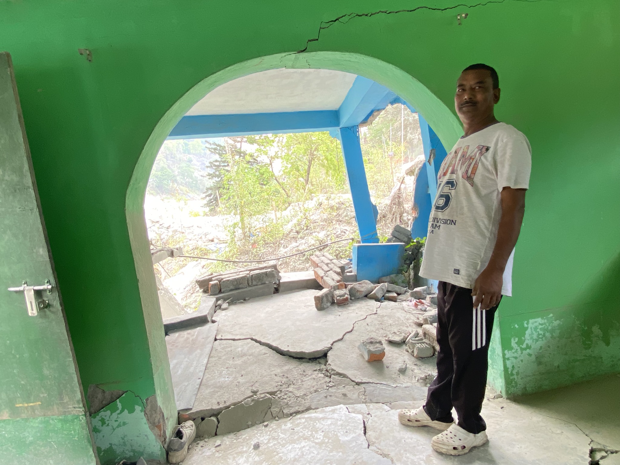 Tikaram Karki’s home and motorcycle repair shop in Teesta Bazar, Kalimpong, are sinking into the Teesta River following the October 2023 flood, which caused massive destruction to property in the region