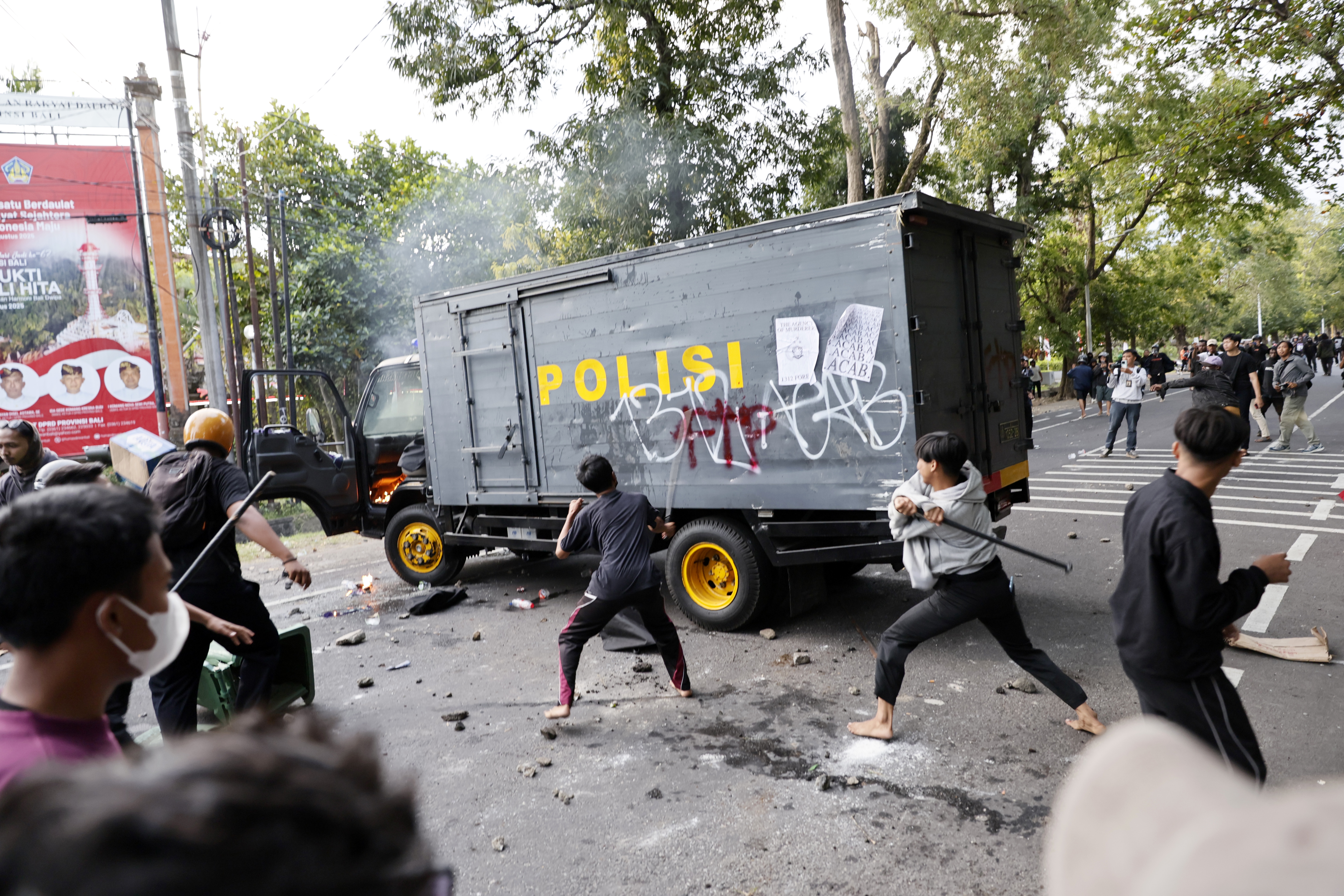 Protesters clash with police outside the parliament building in Denpasar, Bali, Indonesia, on August 30, 2025