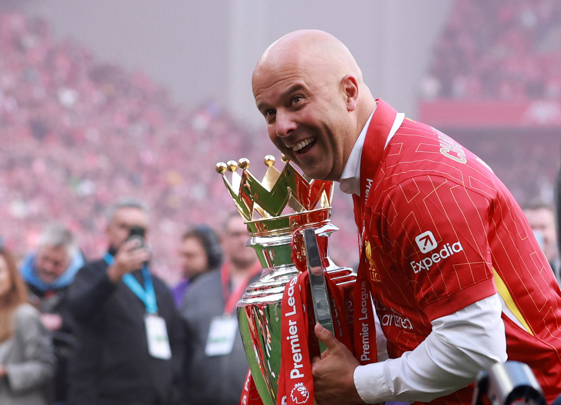 Liverpool manager Arne Slot celebrates with the trophy after winning the Premier League