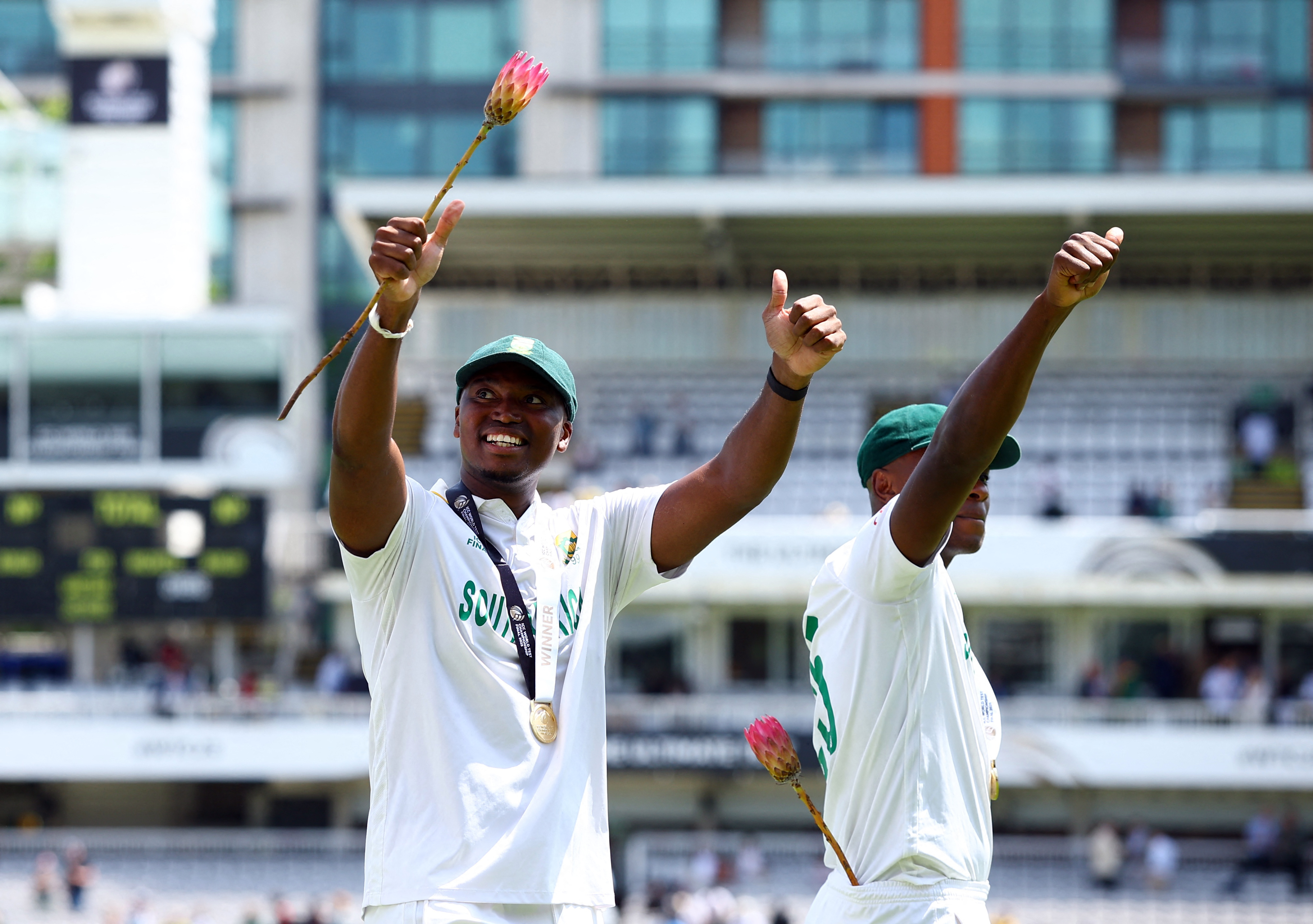 South Africa's Lungi Ngidi and Kagiso Rabada circle the ground and celebrate after winning the 2025 ICC World Test Championship final