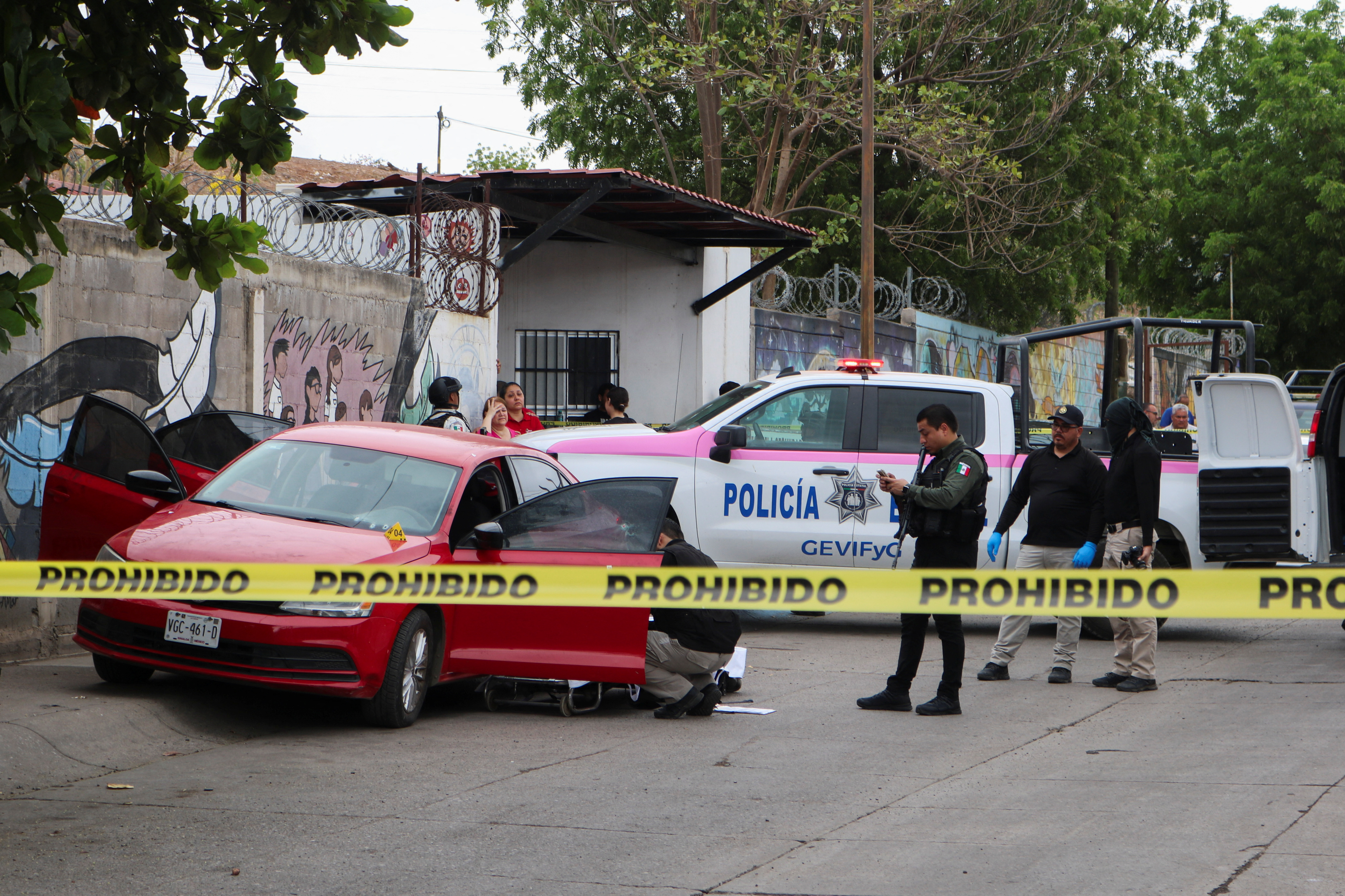 Police officers work in a crime scene where a man was gunned down, as violence and economic turmoil escalate in Culiacan one year after the abduction and extradition of Sinaloa Cartel leader Ismael "El Mayo" Zambada to the United States, in Culiacan