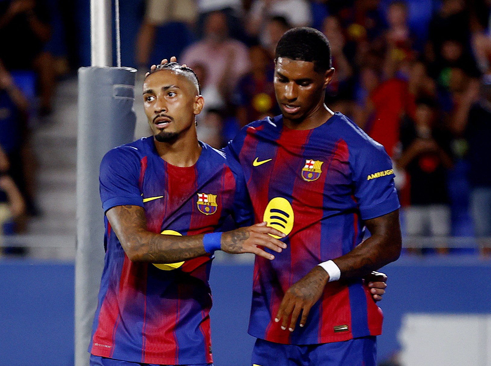 Barcelona's Raphinha celebrates scoring their third goal with Marcus Rashford.