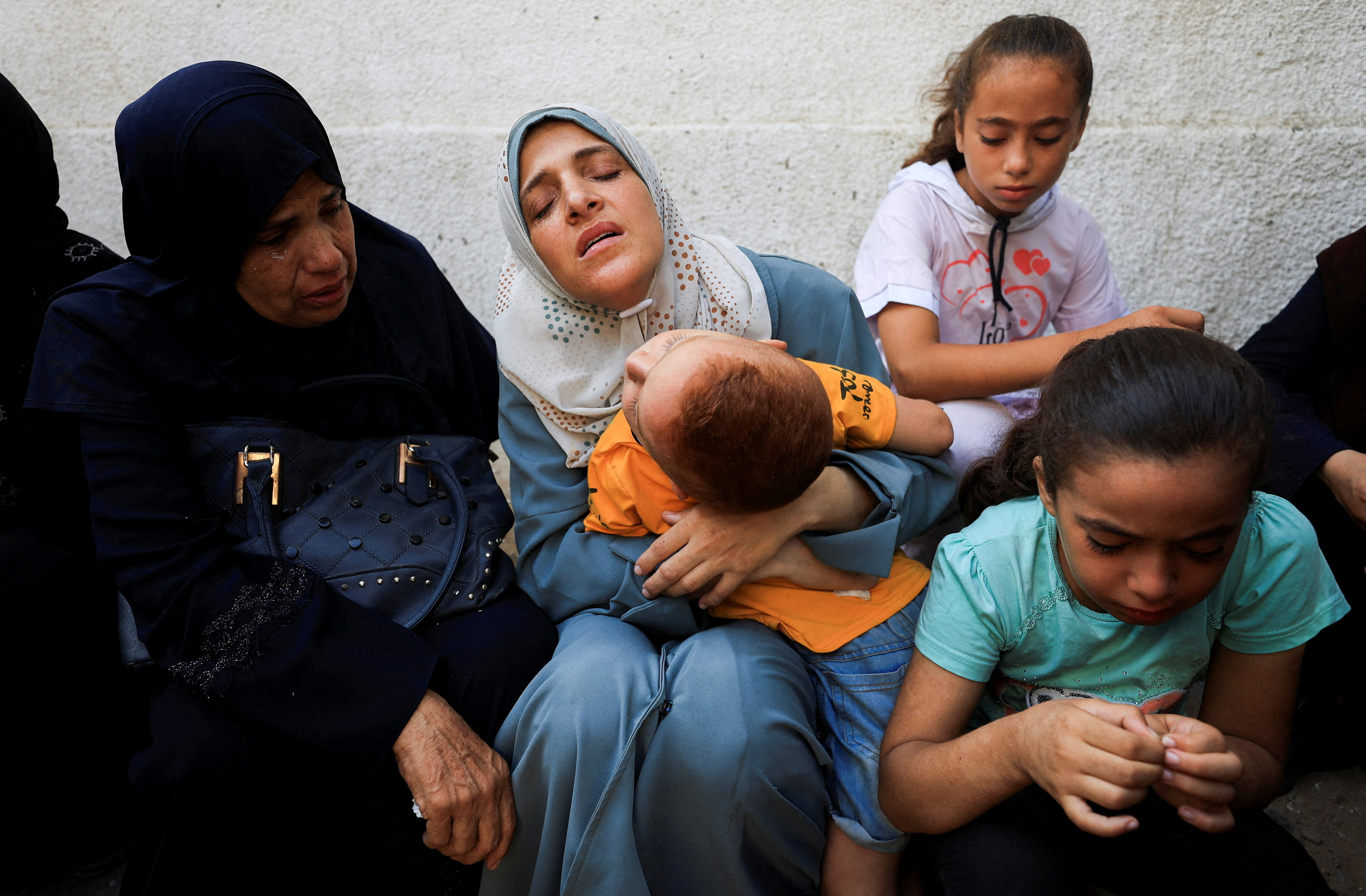 Mourners react during the funeral of Palestinians killed by Israeli attacks